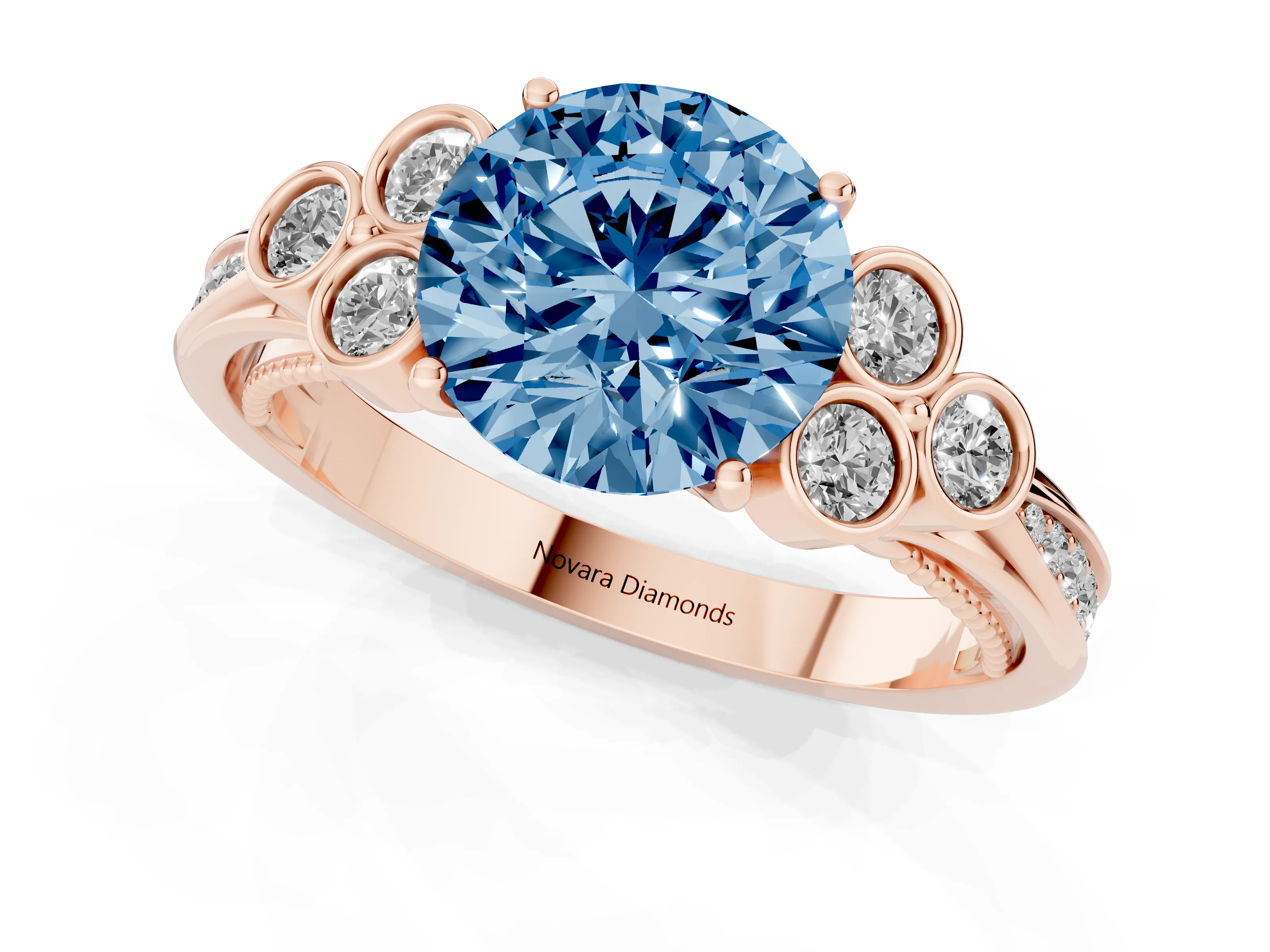 Fancy Blue Round Cut Diamond Engagement Ring Set in Rose gold with Bezel Set Round Side Stones and Prong Setting
