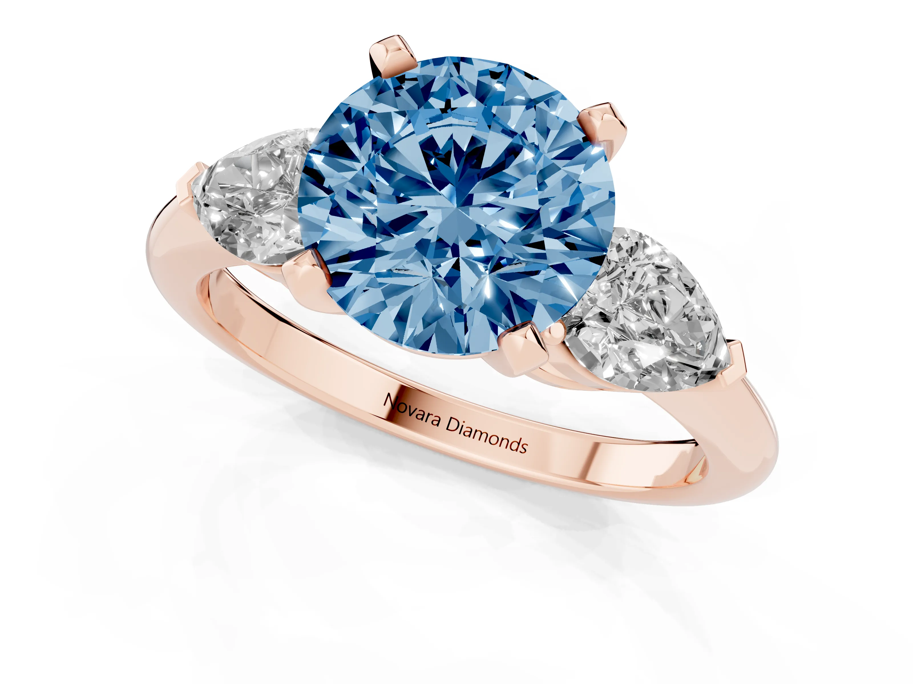 Fancy Blue Three-Stone Round Cut Diamond Ring Set in Rose gold with Pear Side Stones and Prong Setting
