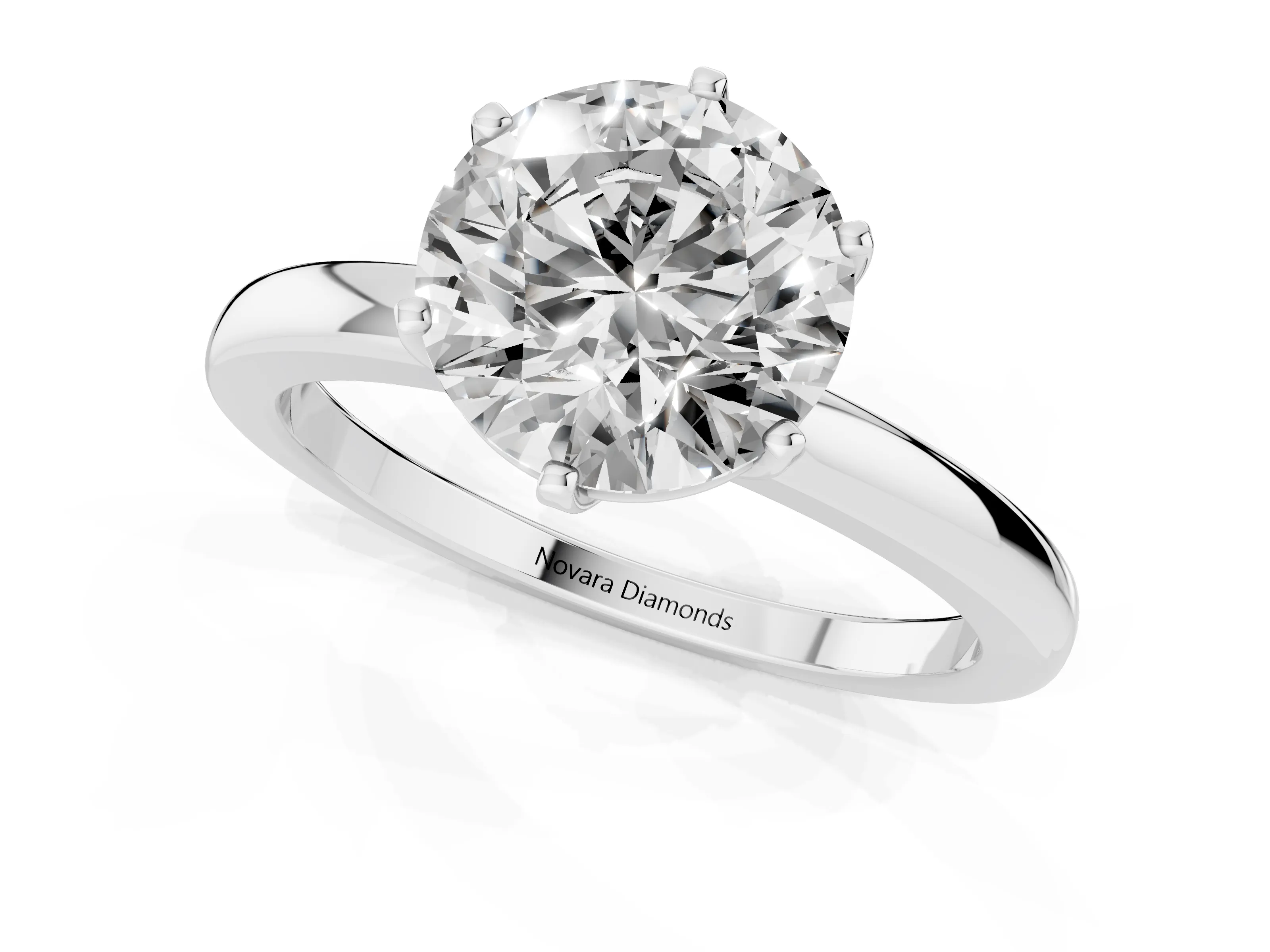 Round Cut Diamond Solitaire Ring Set in Silver with Raised Prong Setting on a Classic Band