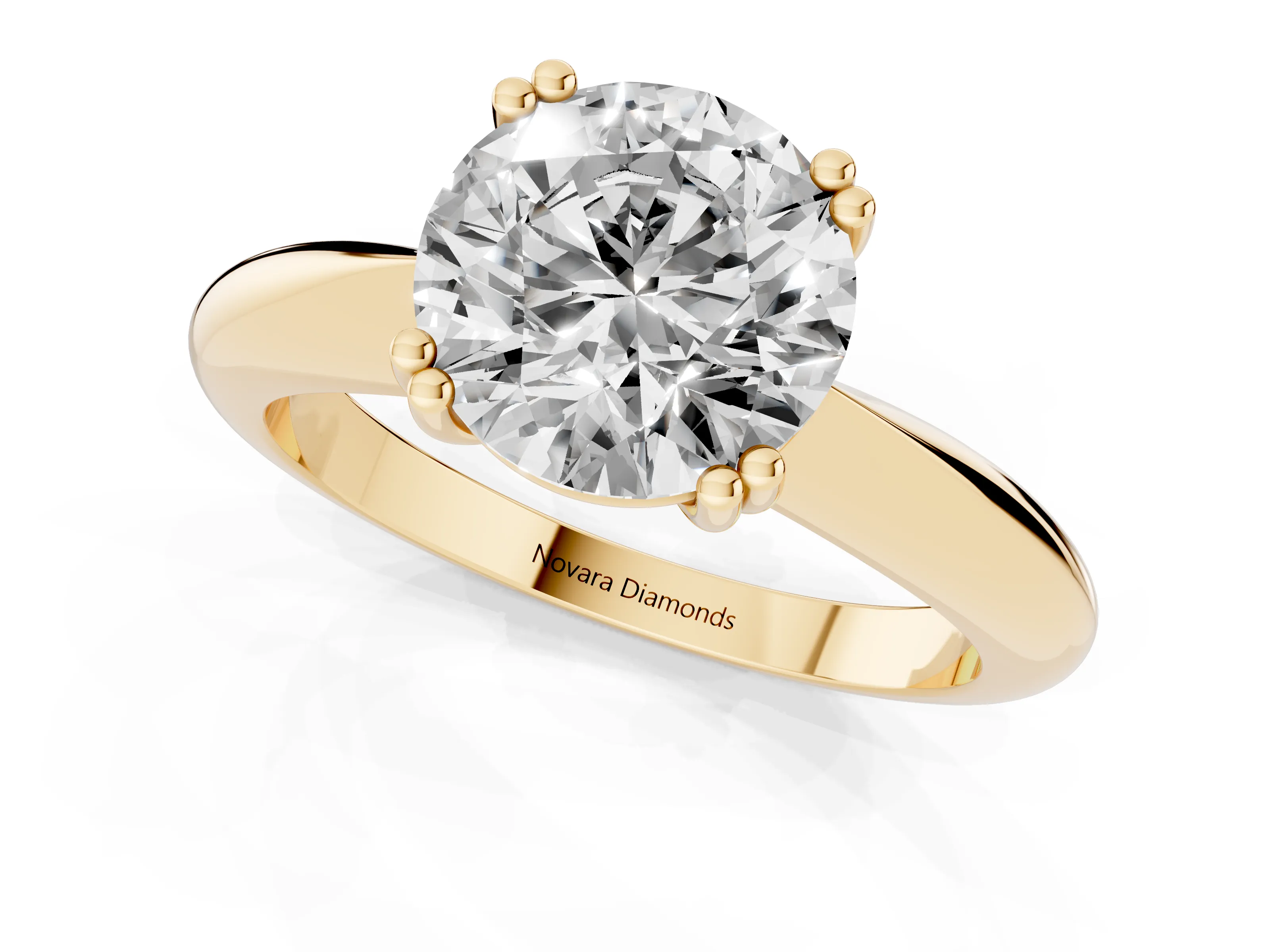 Round Cut Diamond Solitaire Engagement Ring Set in Yellow gold with Tapered Band and Prong Setting
