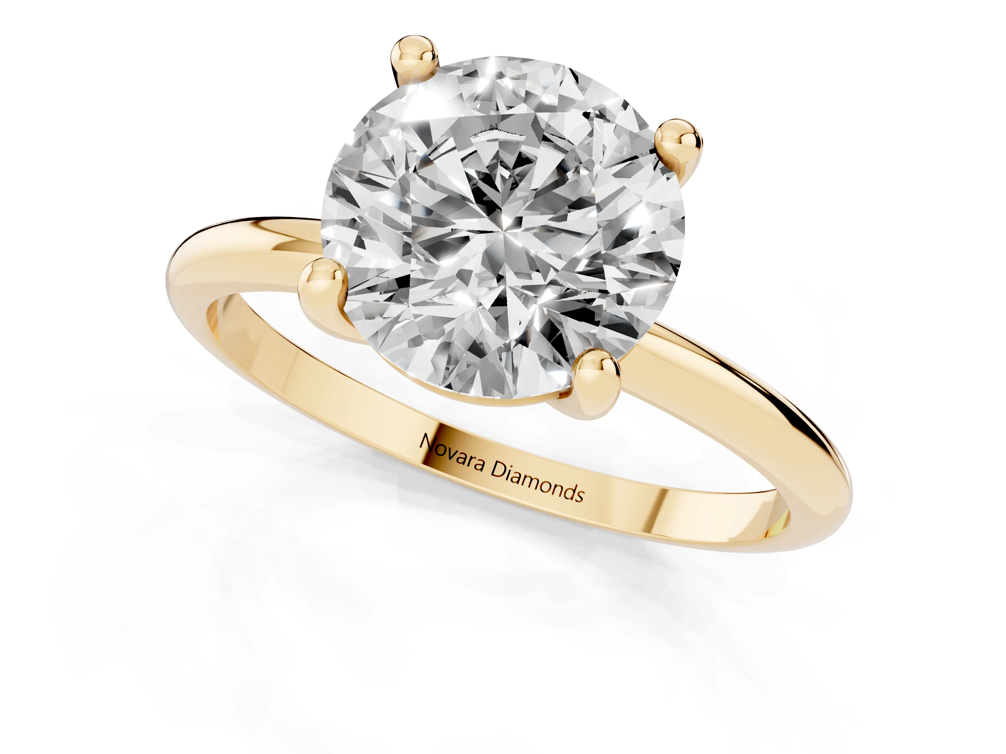 Round Cut Diamond Solitaire Ring Set in Yellow gold with Secure Prong Setting on a Classic Band