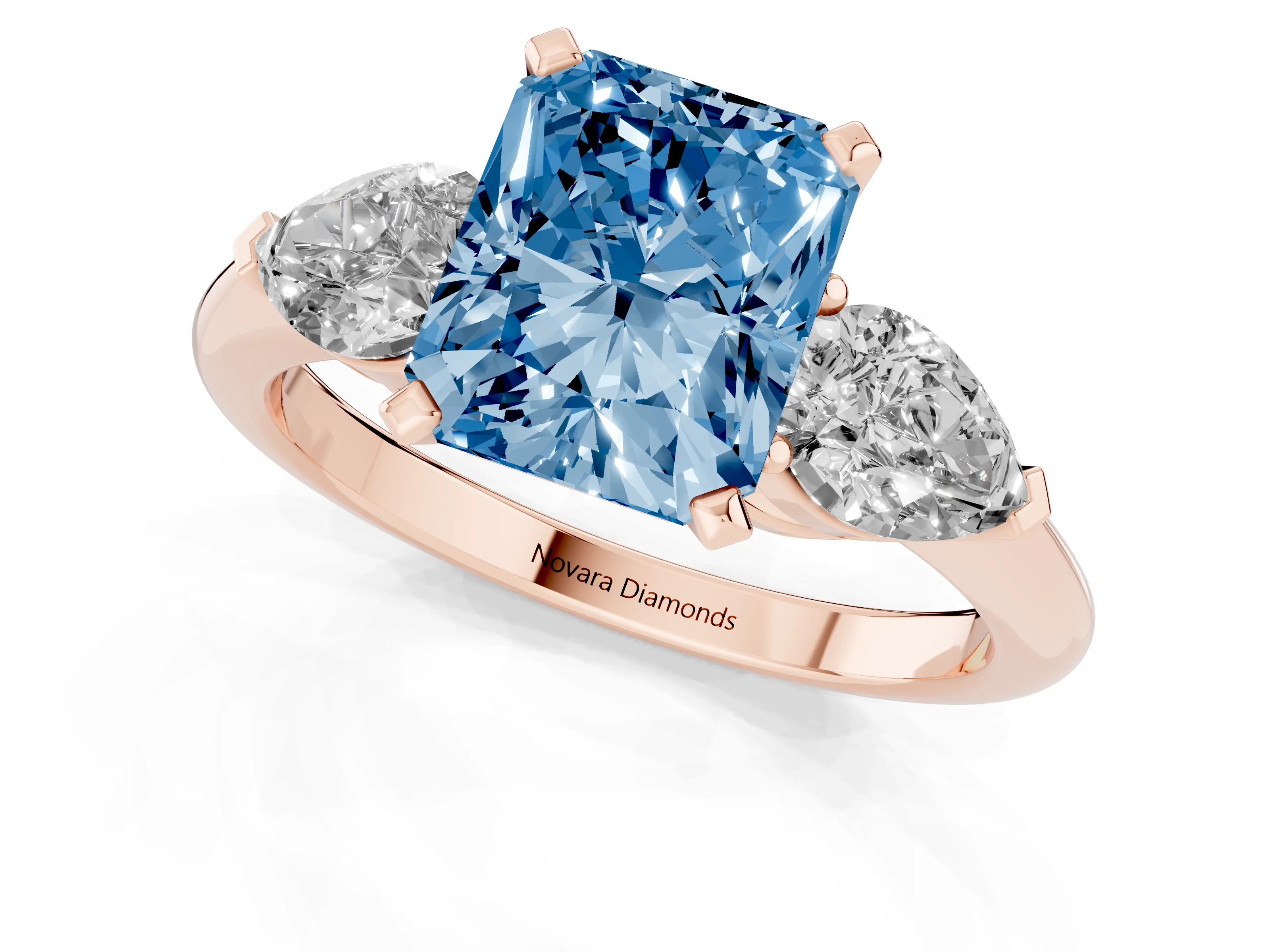 Fancy Blue Three-Stone Radiant Cut Diamond Ring Set in Rose gold with Pear Side Stones and Prong Setting