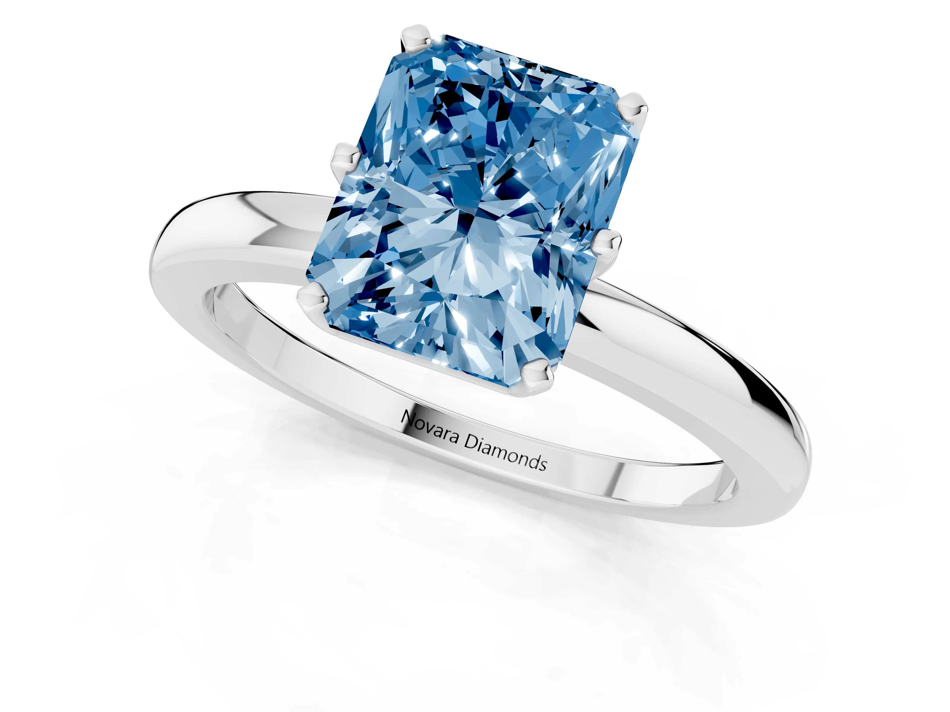 Fancy Blue Radiant Cut Diamond Solitaire Ring Set in Silver with Raised Prong Setting on a Classic Band
