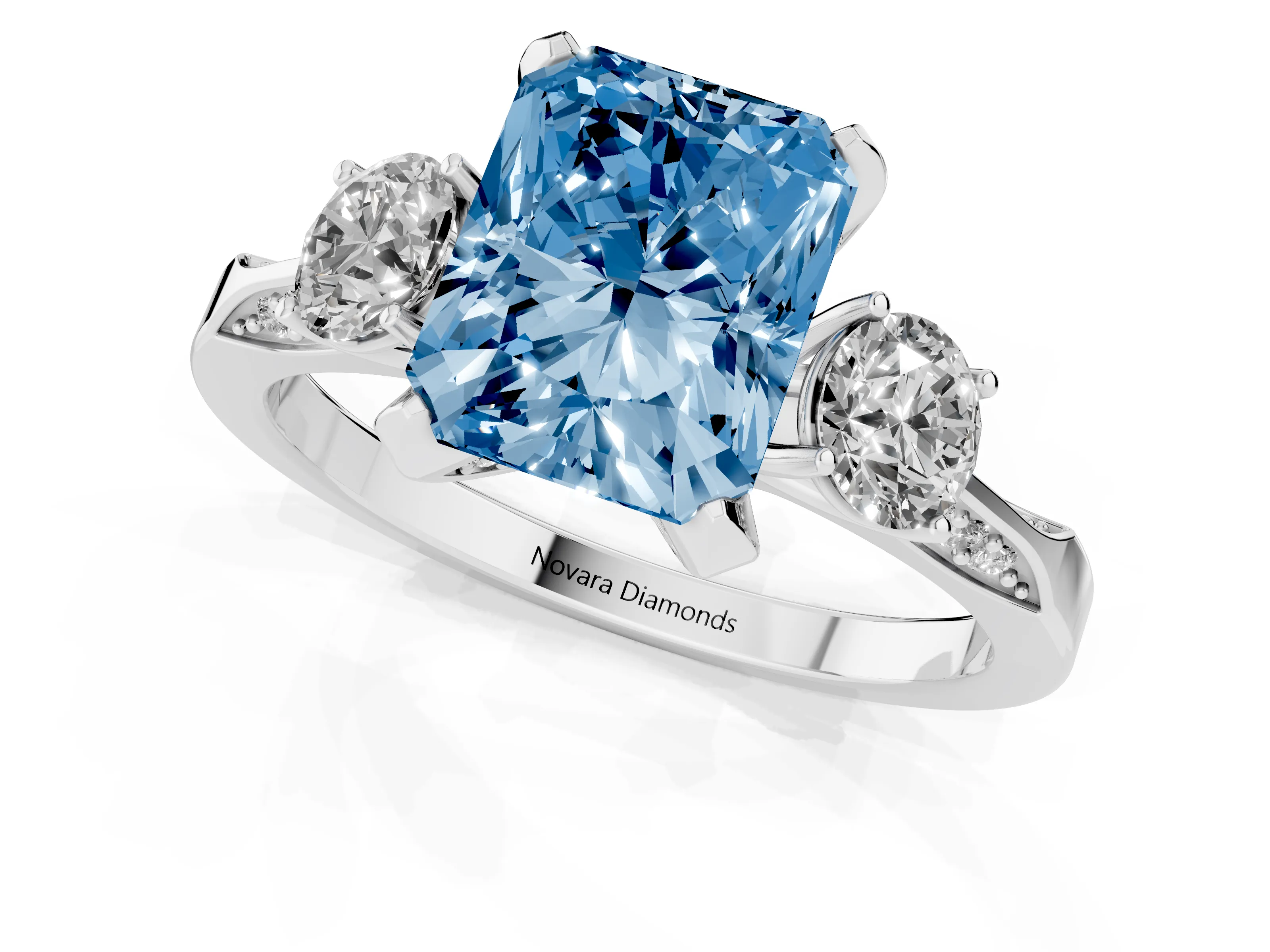 Fancy Blue Radiant Cut Diamond Three-Stone Ring Set in White gold with Pavé Band and Smaller Side Stones