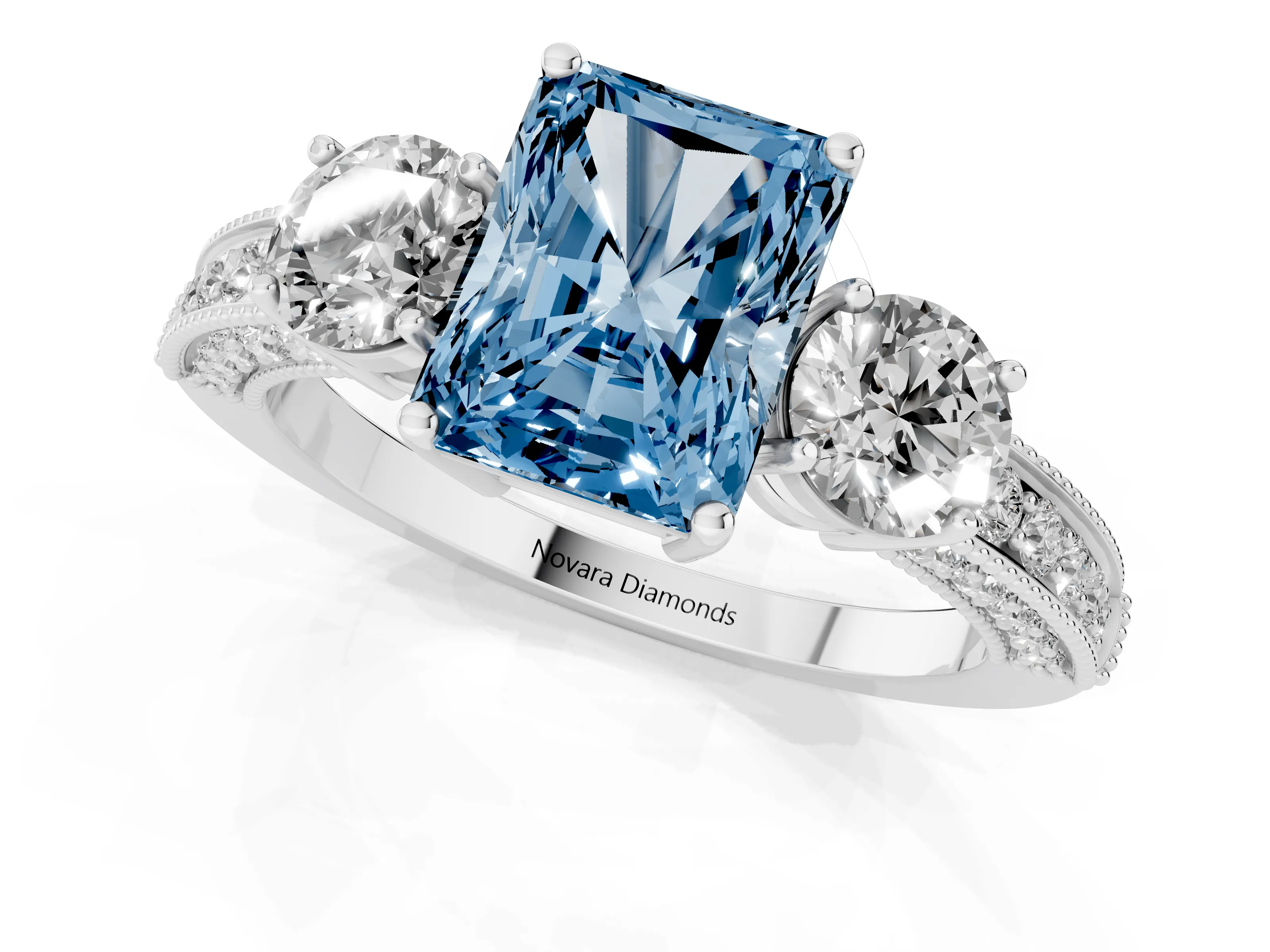 Fancy Blue Radiant Cut Diamond Three-Stone Ring Set in Platinum with Round Side Stones and Pavé Band