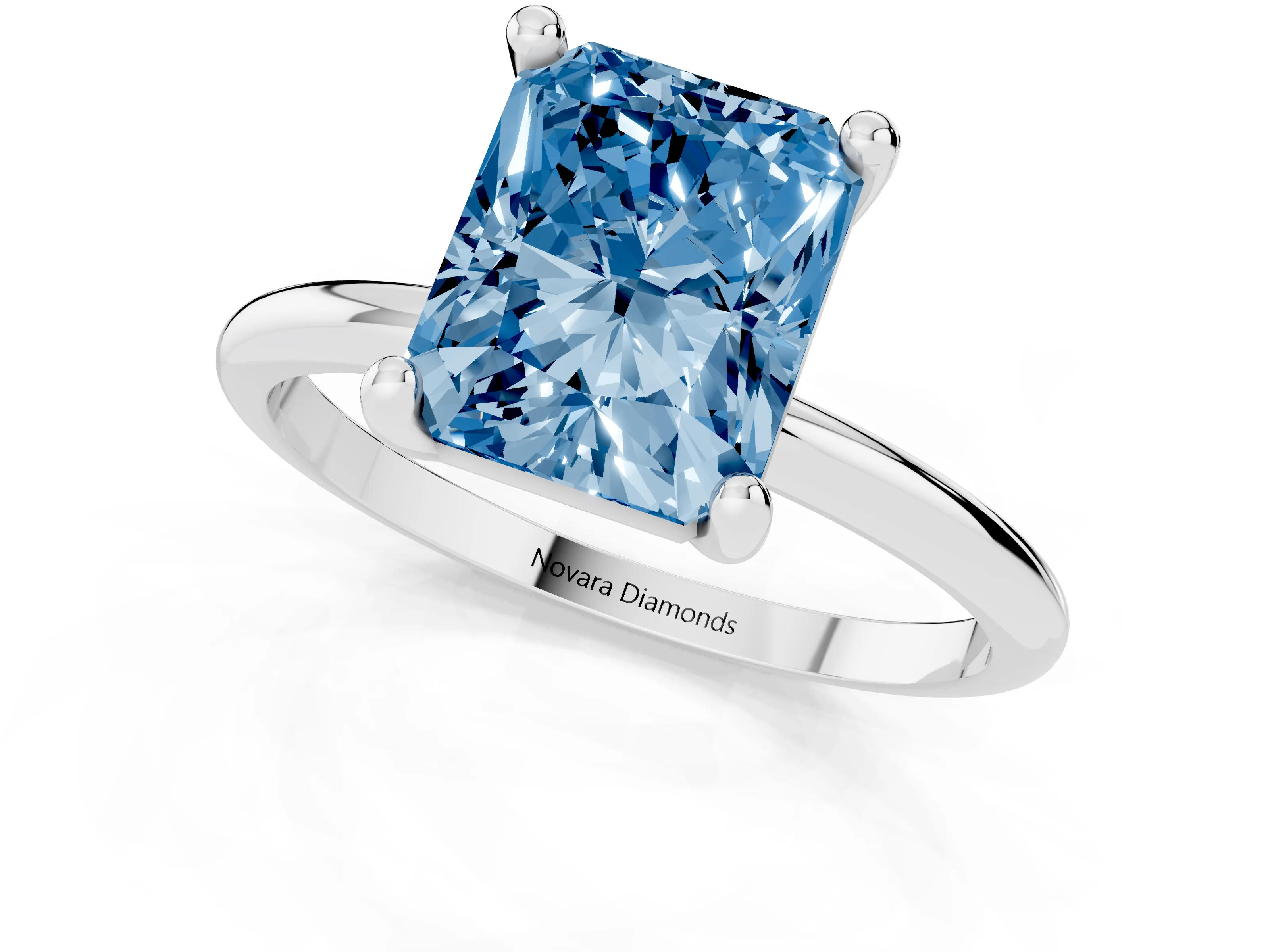 Fancy Blue Radiant Cut Diamond Solitaire Ring Set in White gold with Secure Prong Setting on a Classic Band