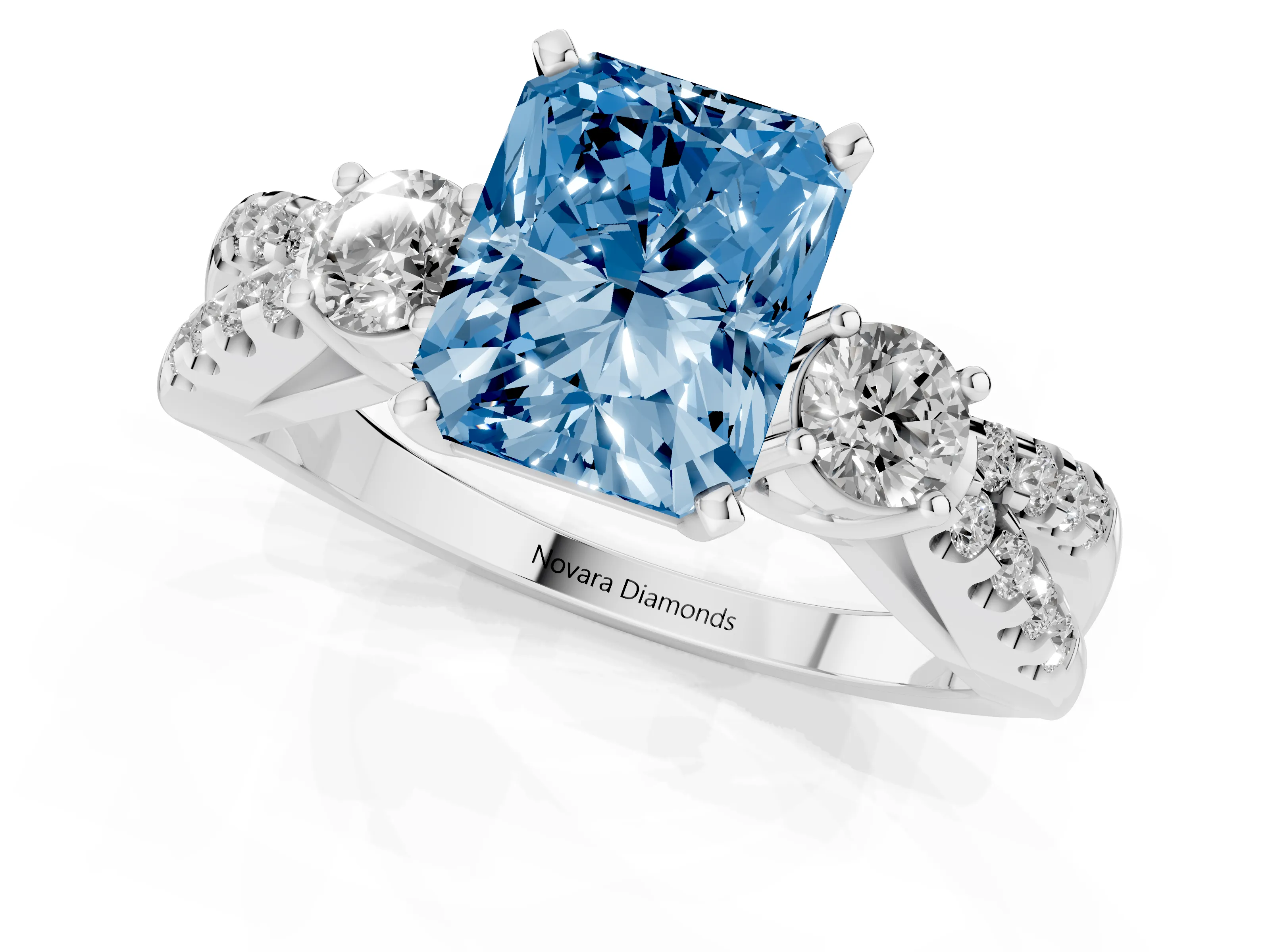 Fancy Blue Radiant Cut Diamond Three-Stone Ring Set in White gold with Pavé Split Shank and Prong Setting
