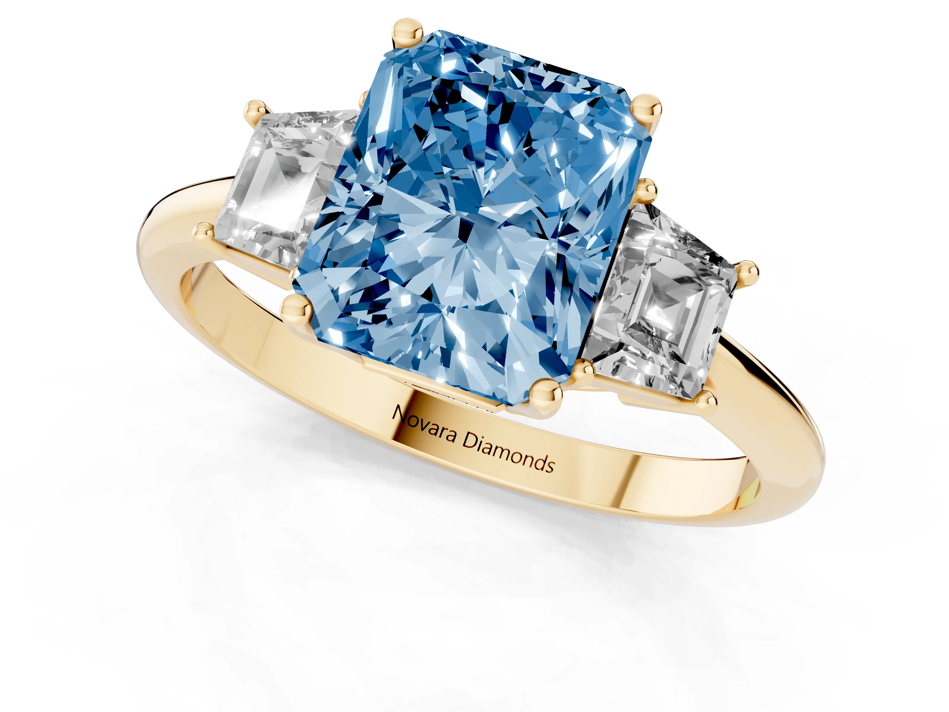 Fancy Blue Radiant Cut Diamond Three-Stone Ring Set in Yellow gold with Trapezoid Side Stones and Prong Setting