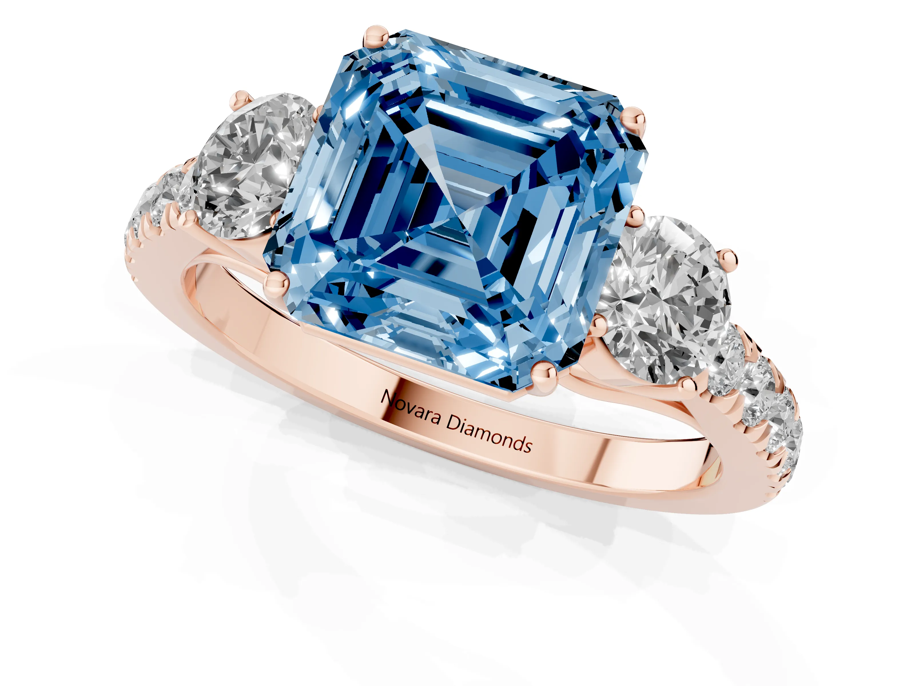 Fancy Blue Asscher Cut Diamond Three-Stone Ring Set in Rose gold with Round Side Stones and Delicate Pavé Band