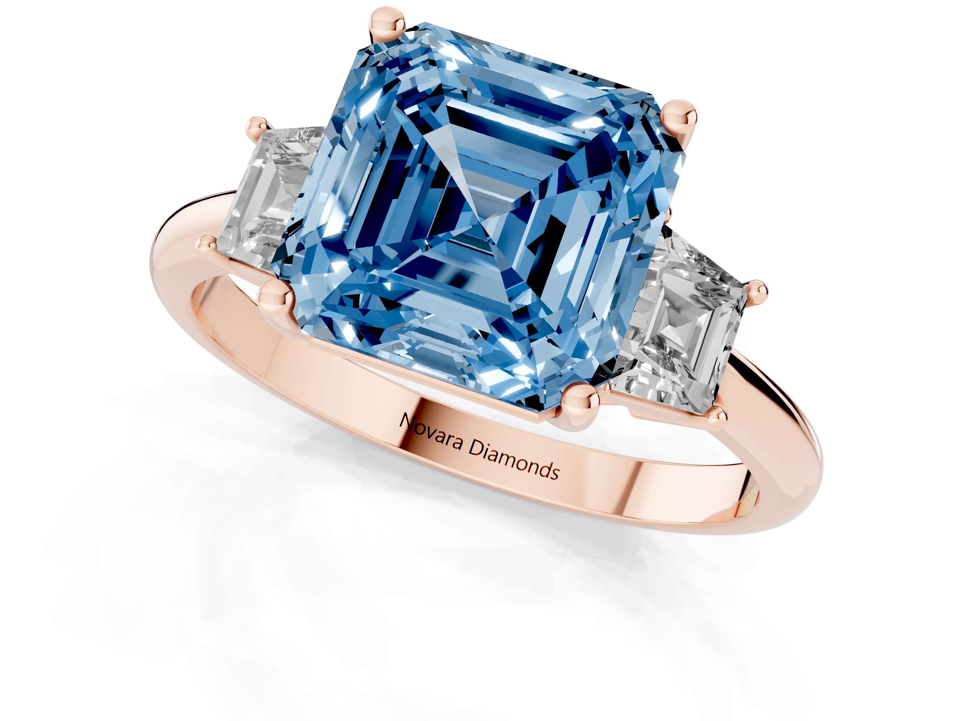 Fancy Blue Asscher Cut Diamond Three-Stone Ring Set in Rose gold with Trapezoid Side Stones and Prong Setting