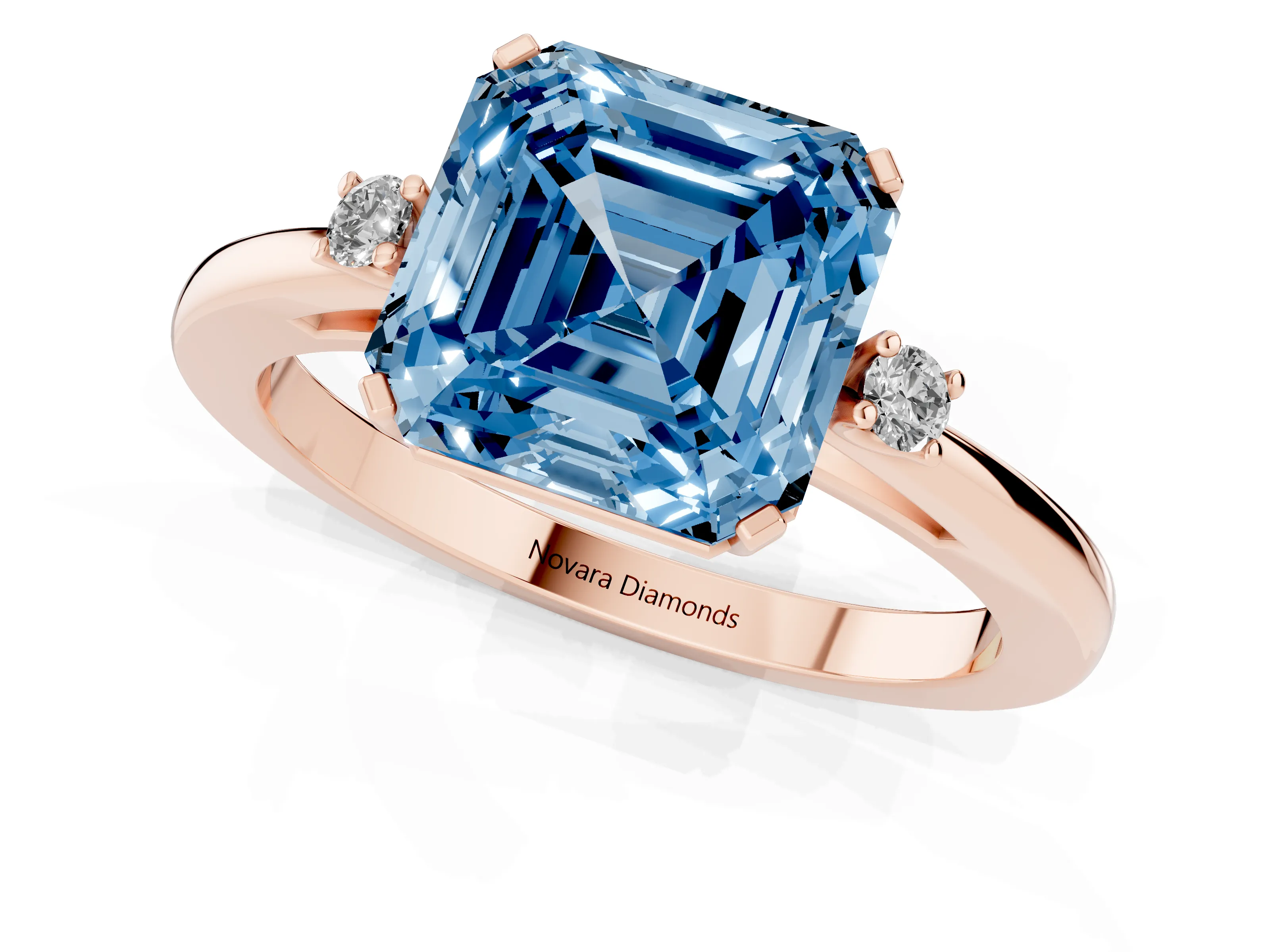 Fancy Blue Three-Stone Asscher Cut Diamond Solitaire Ring Set in Rose gold with Round Accent Stones and Prong Setting