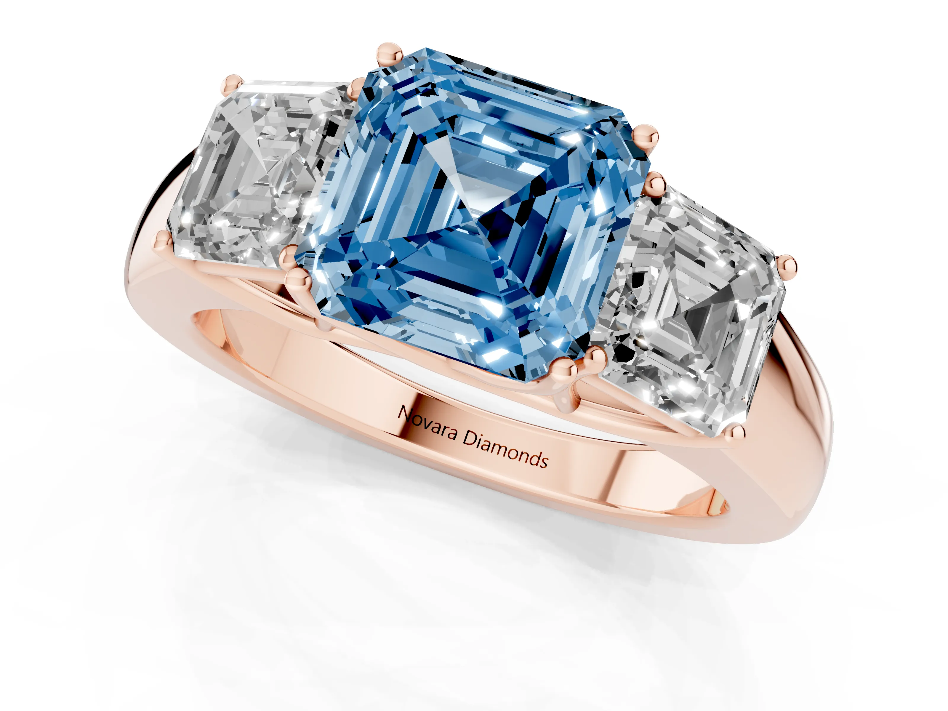Fancy Blue Three-Stone Asscher Cut Diamond Ring Set in Rose gold with Matching Prong Settings and Plain Band