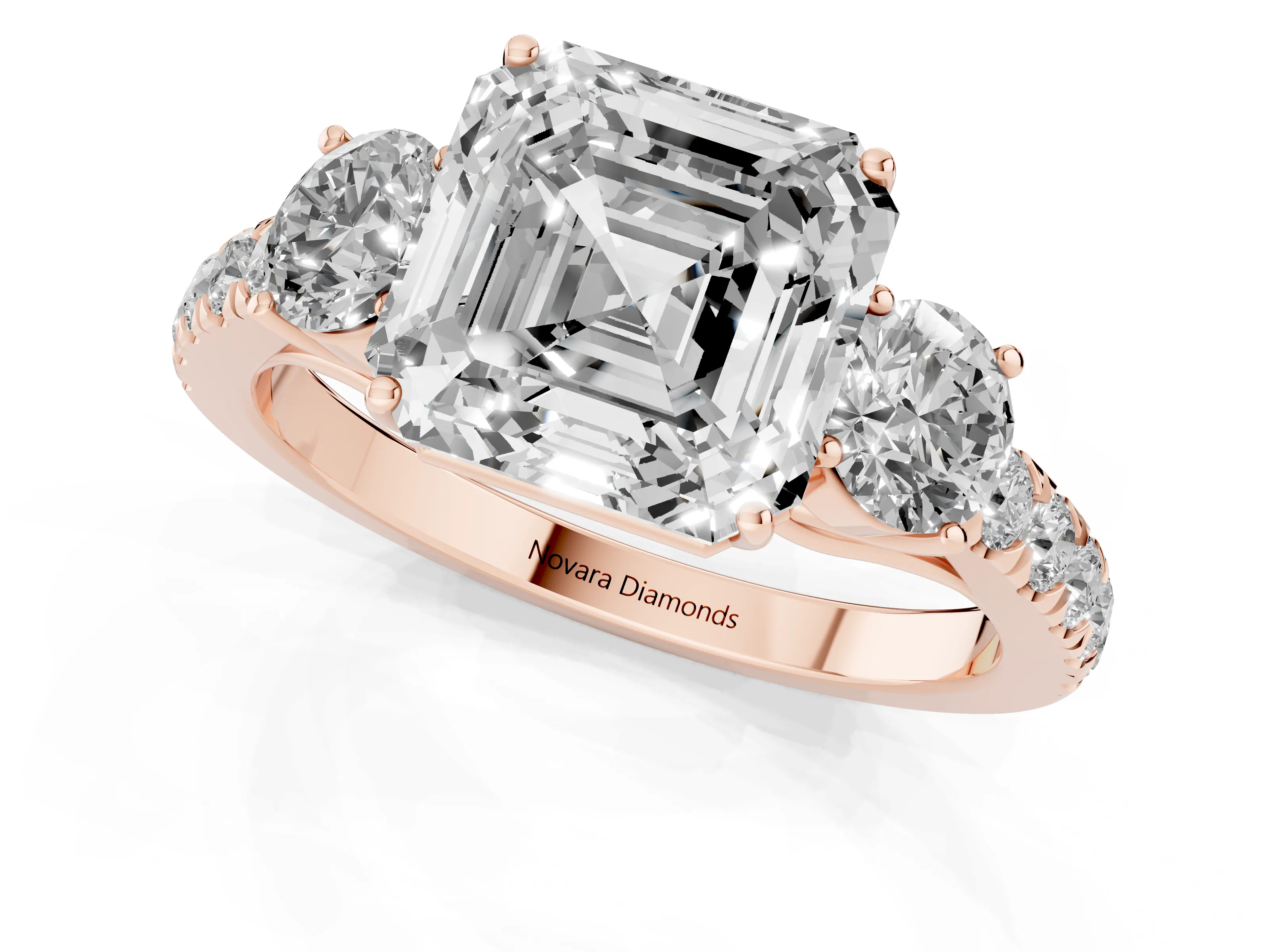 Asscher Cut Diamond Three-Stone Ring Set in Rose gold with Round Side Stones and Delicate Pavé Band