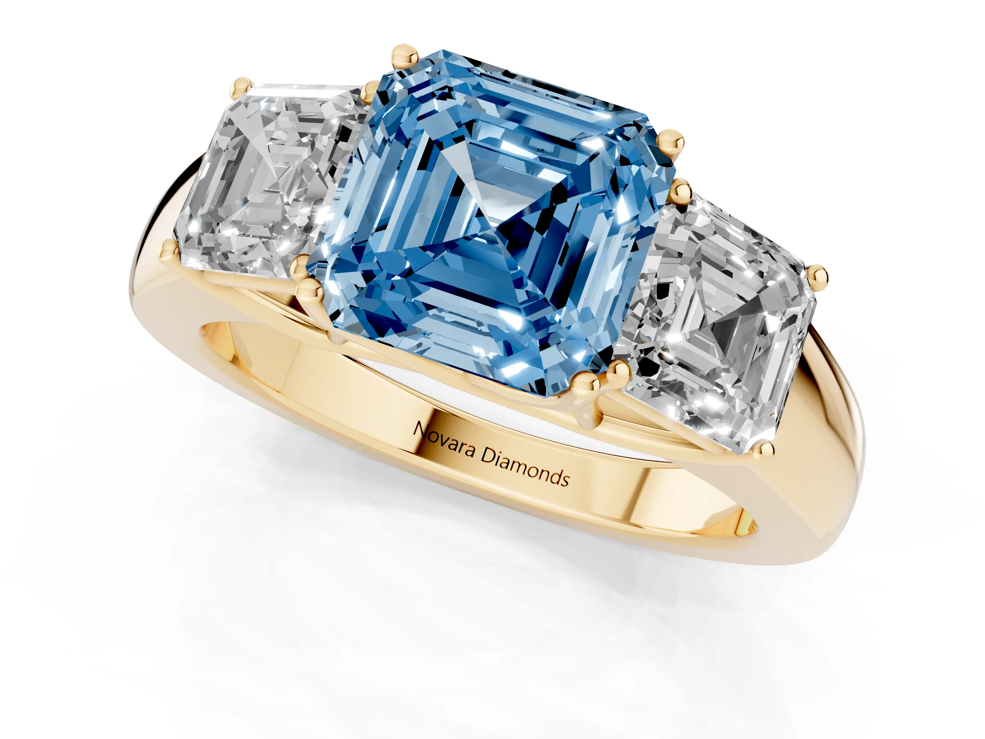 Fancy Blue Three-Stone Asscher Cut Diamond Ring Set in Yellow gold with Matching Prong Settings and Plain Band