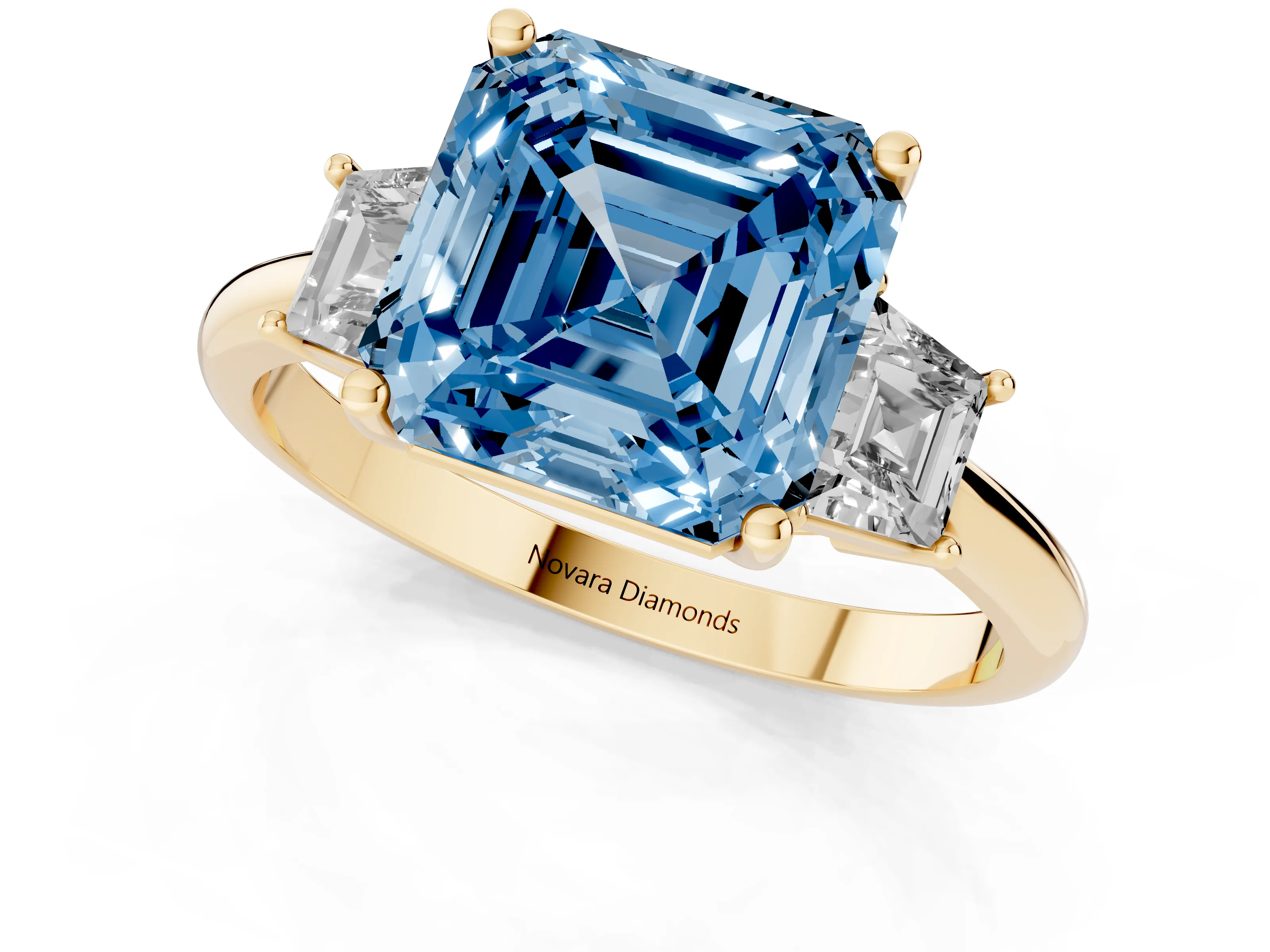 Fancy Blue Asscher Cut Diamond Three-Stone Ring Set in Yellow gold with Trapezoid Side Stones and Prong Setting