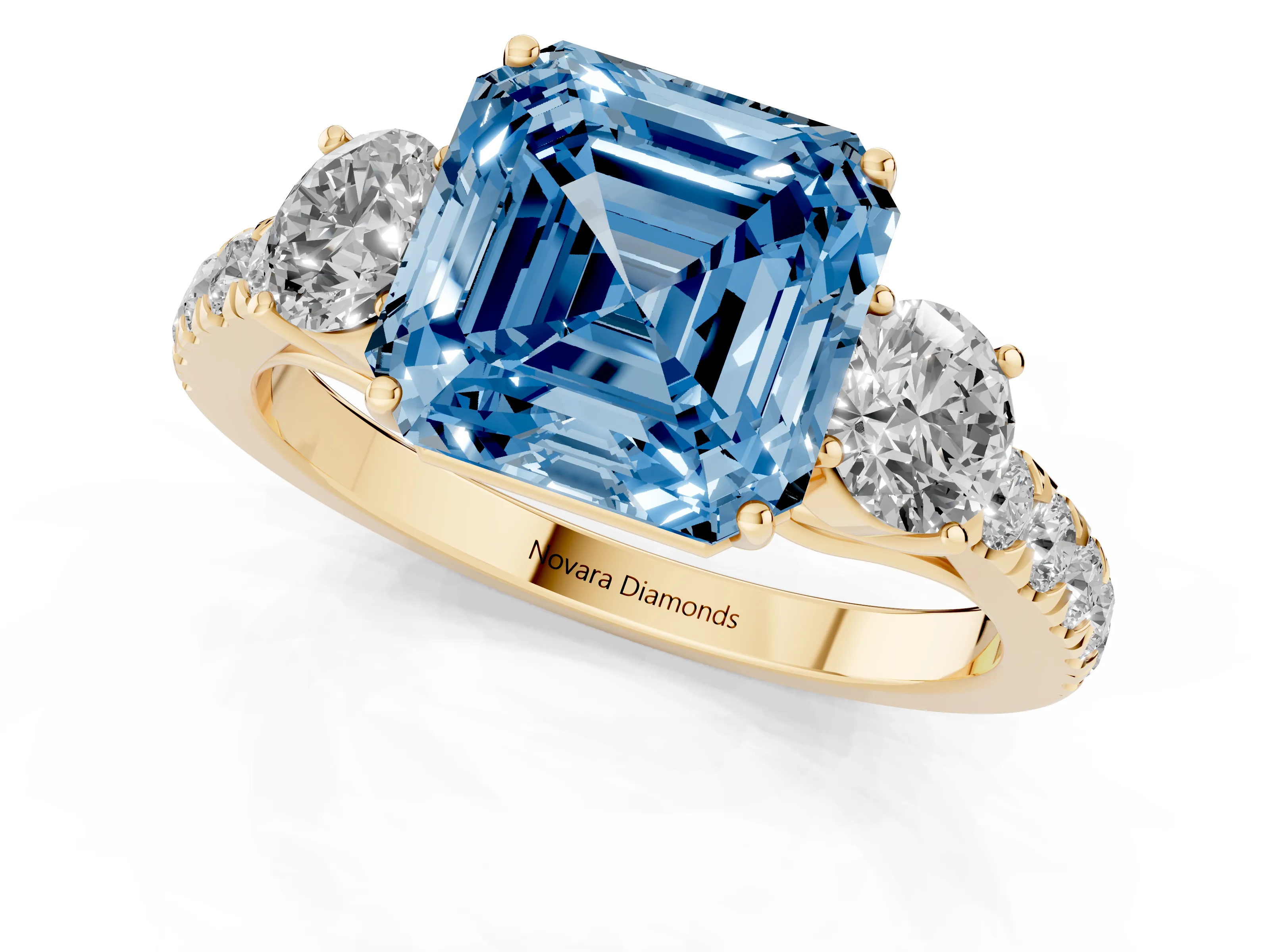 Fancy Blue Asscher Cut Diamond Three-Stone Ring Set in Yellow gold with Round Side Stones and Delicate Pavé Band