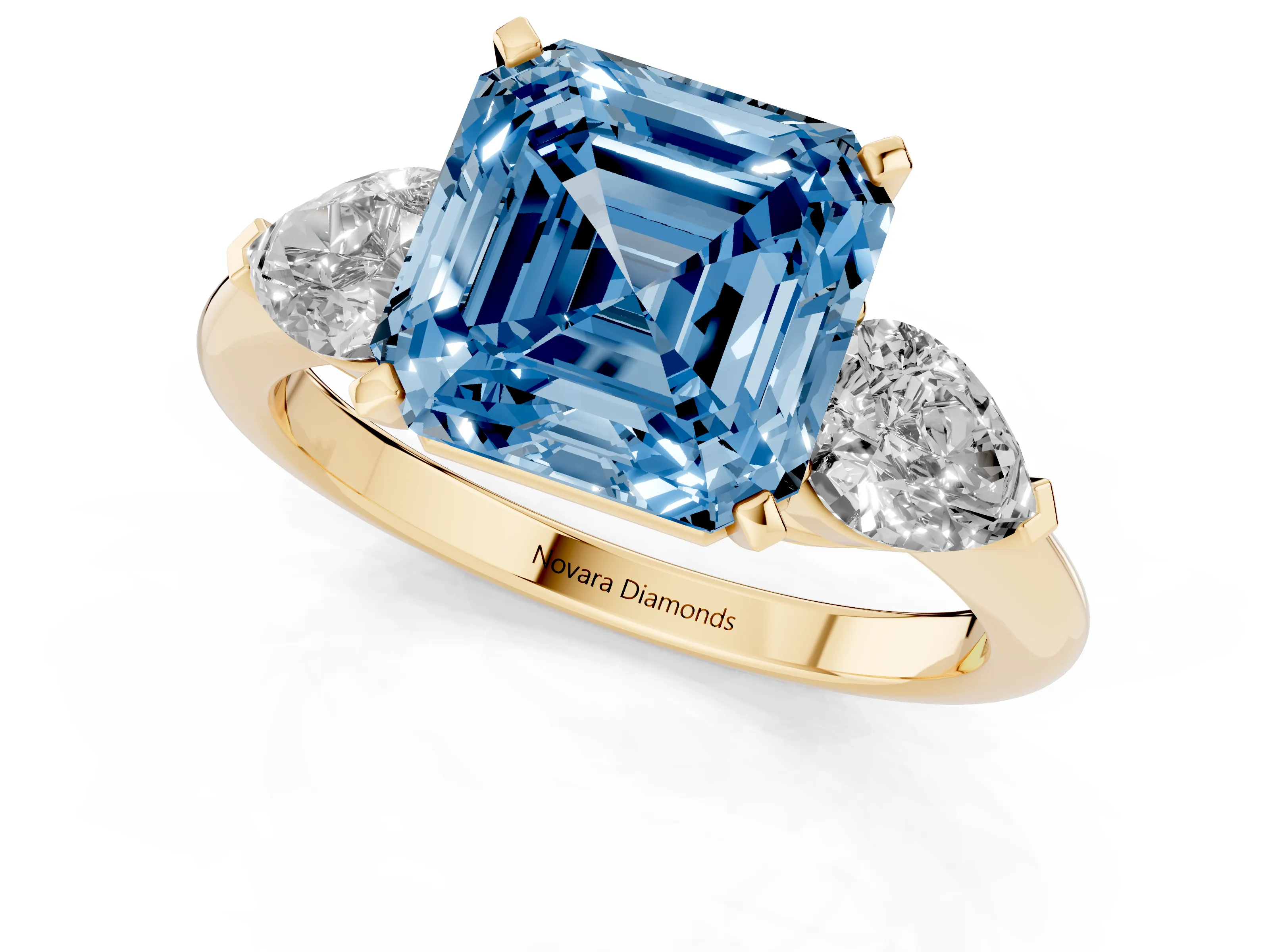 Fancy Blue Three-Stone Asscher Cut Diamond Ring Set in Yellow gold with Pear Side Stones and Prong Setting