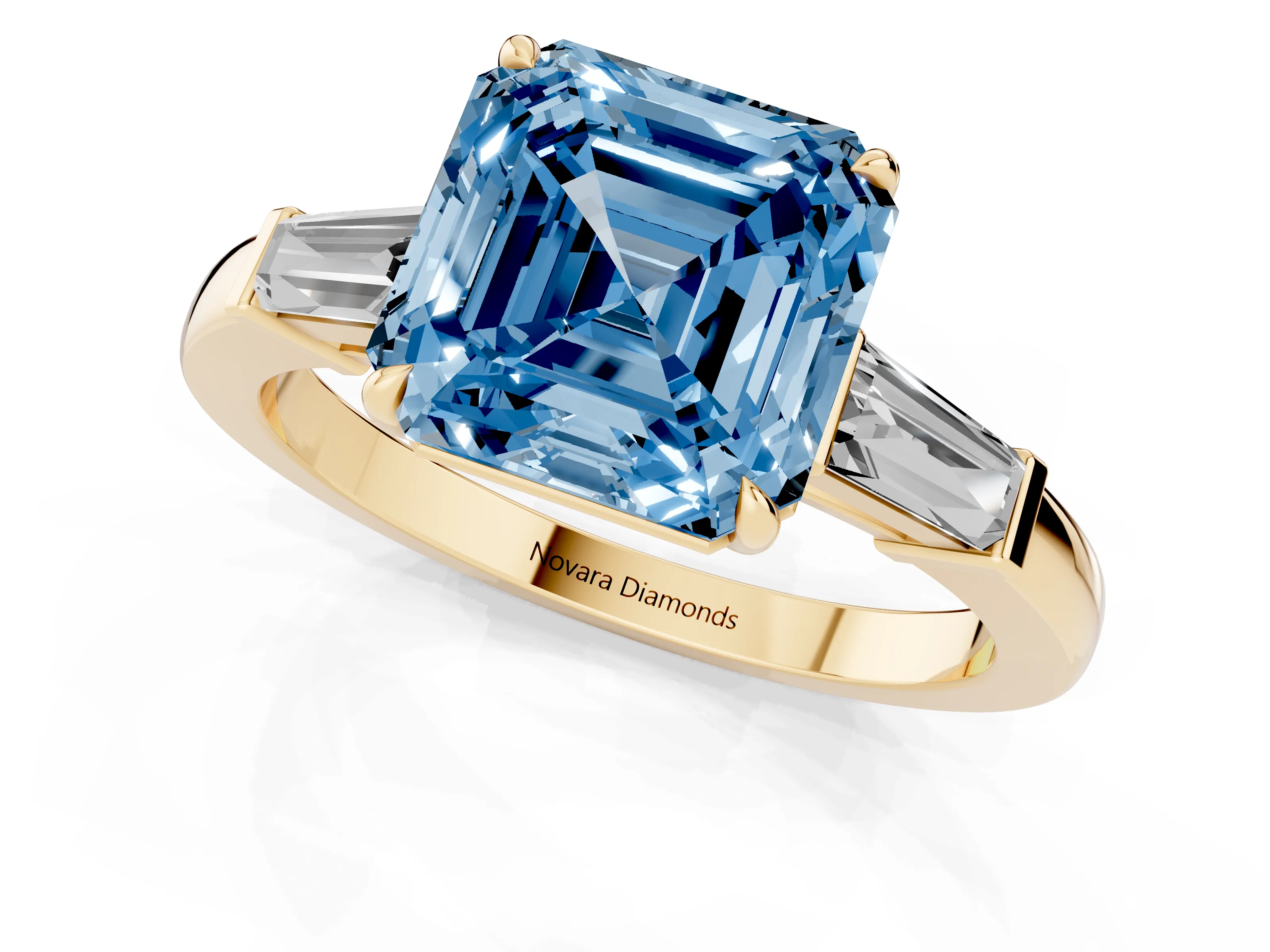 Fancy Blue Asscher Cut Diamond Three-Stone Ring Set in Yellow gold with Tapered Baguette Side Stones and Prong Setting