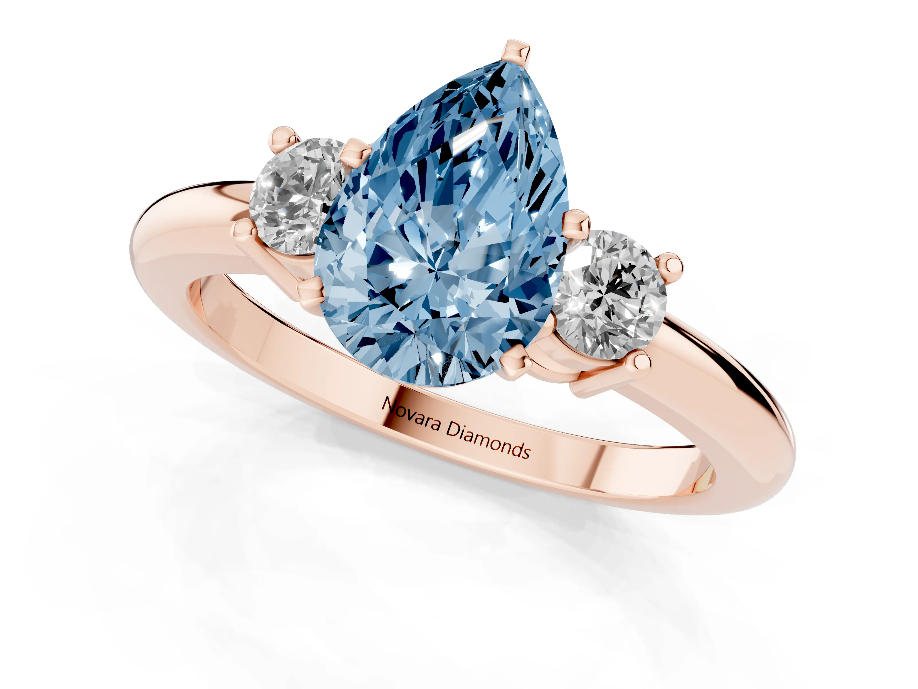 Fancy Blue Three-Stone Pear Cut Diamond Ring Set in Rose gold with Prong Setting and Plain Band
