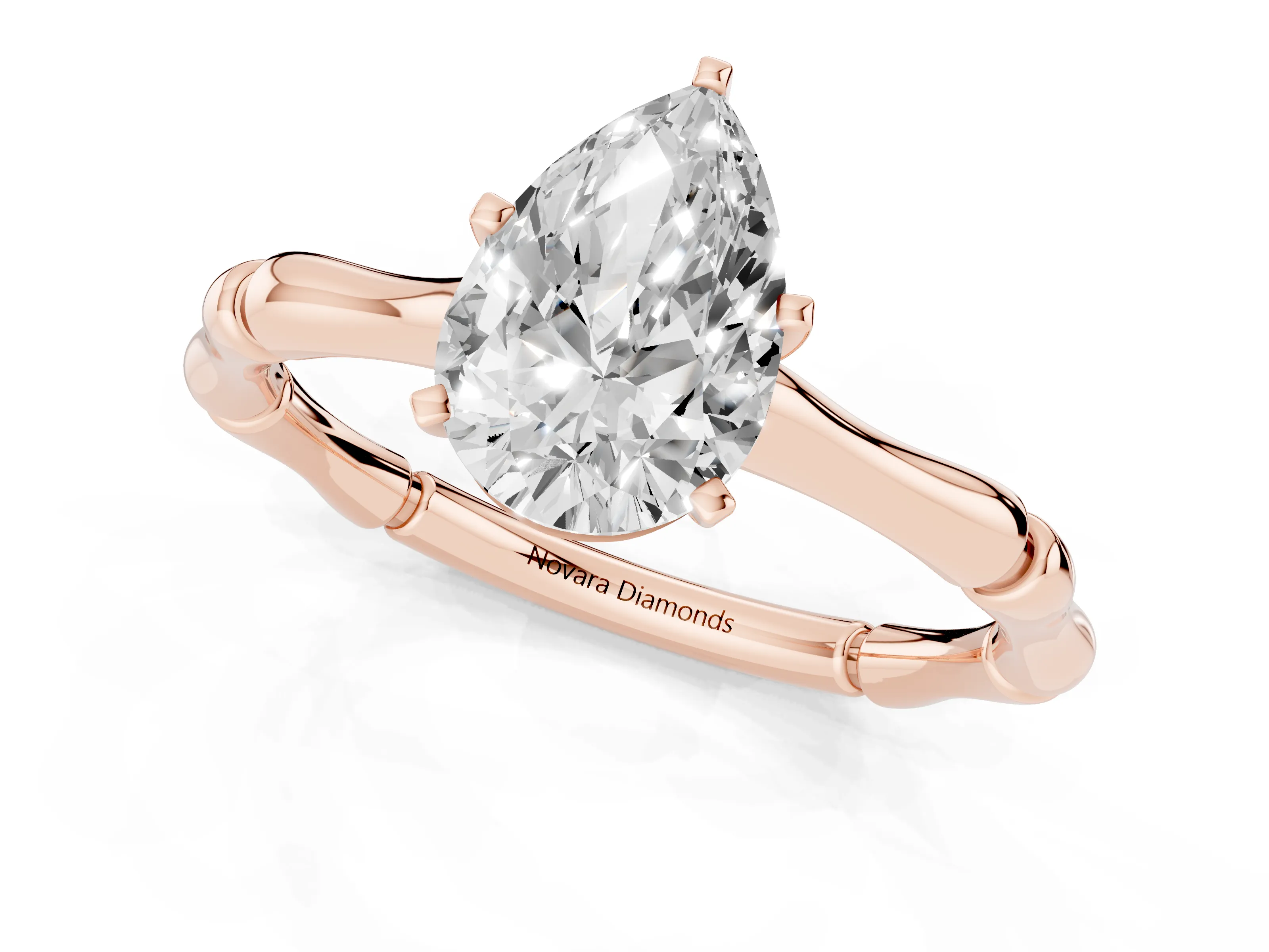 Pear Cut Diamond Solitaire Ring Set in Rose gold with Bamboo Band and Prong Setting