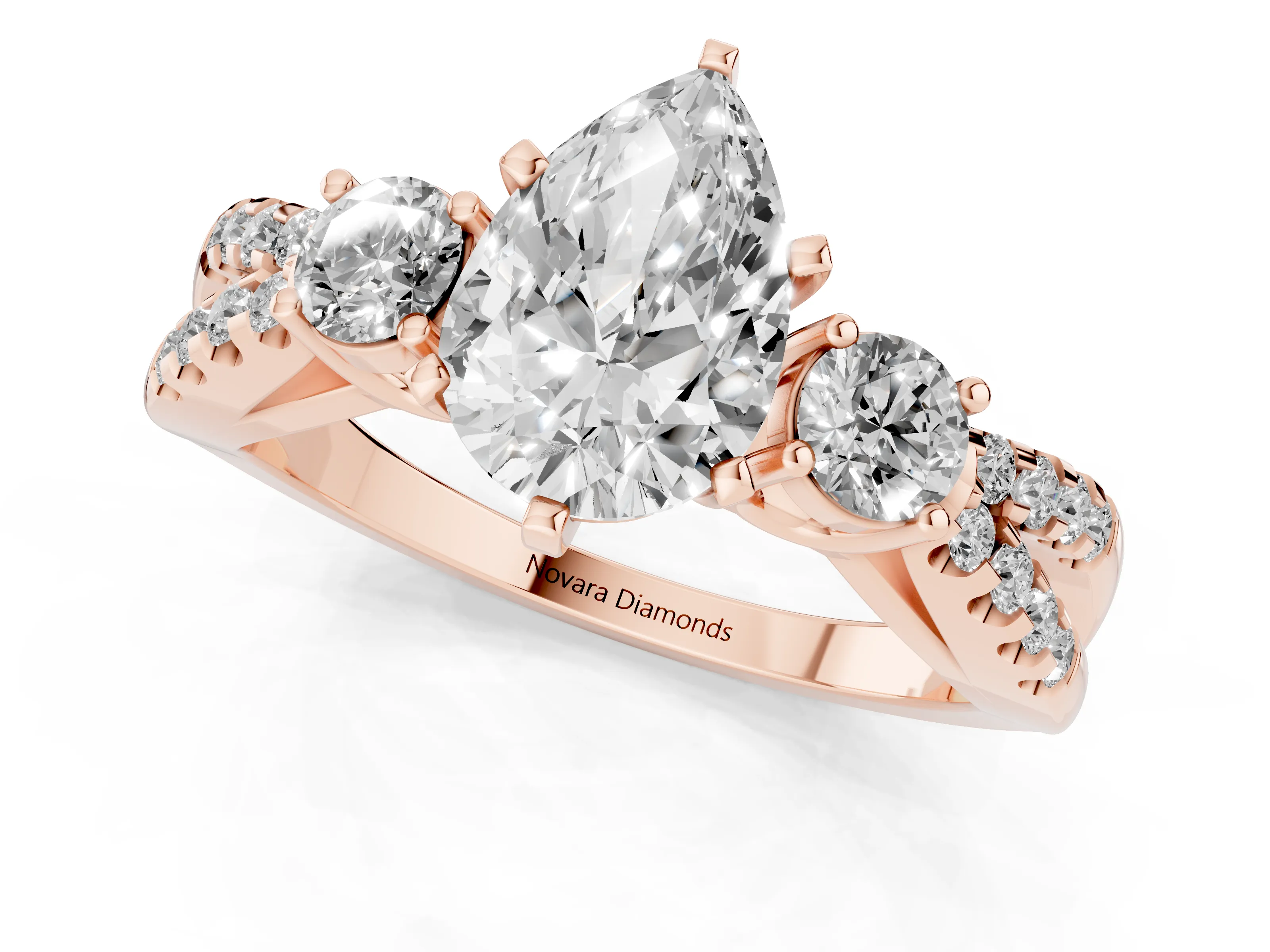 Pear Cut Diamond Three-Stone Ring Set in Rose gold with Pavé Split Shank and Prong Setting