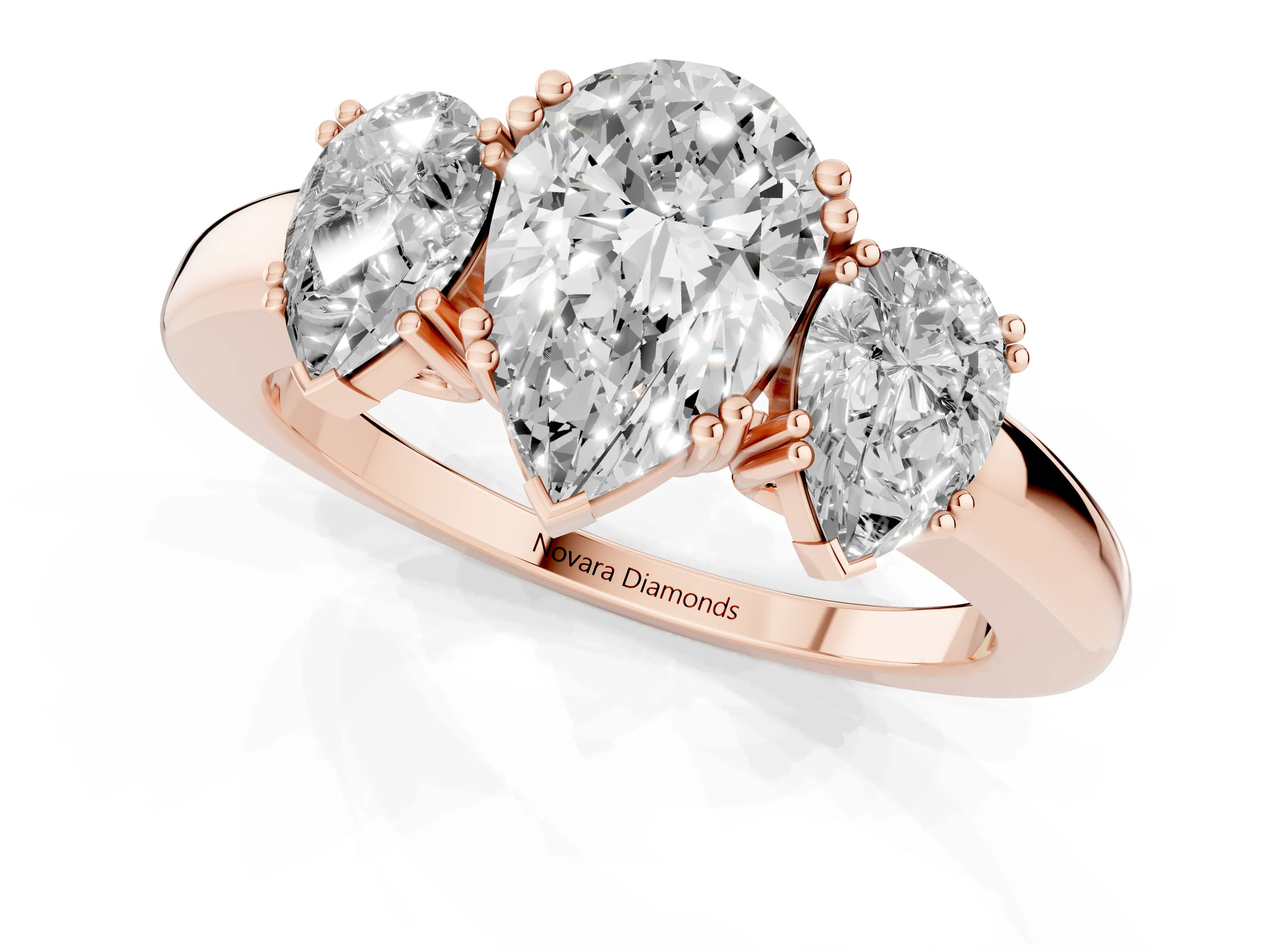 Pear Cut Diamond Three-Stone Ring Set in Rose gold with Polished Channel-Set Band
