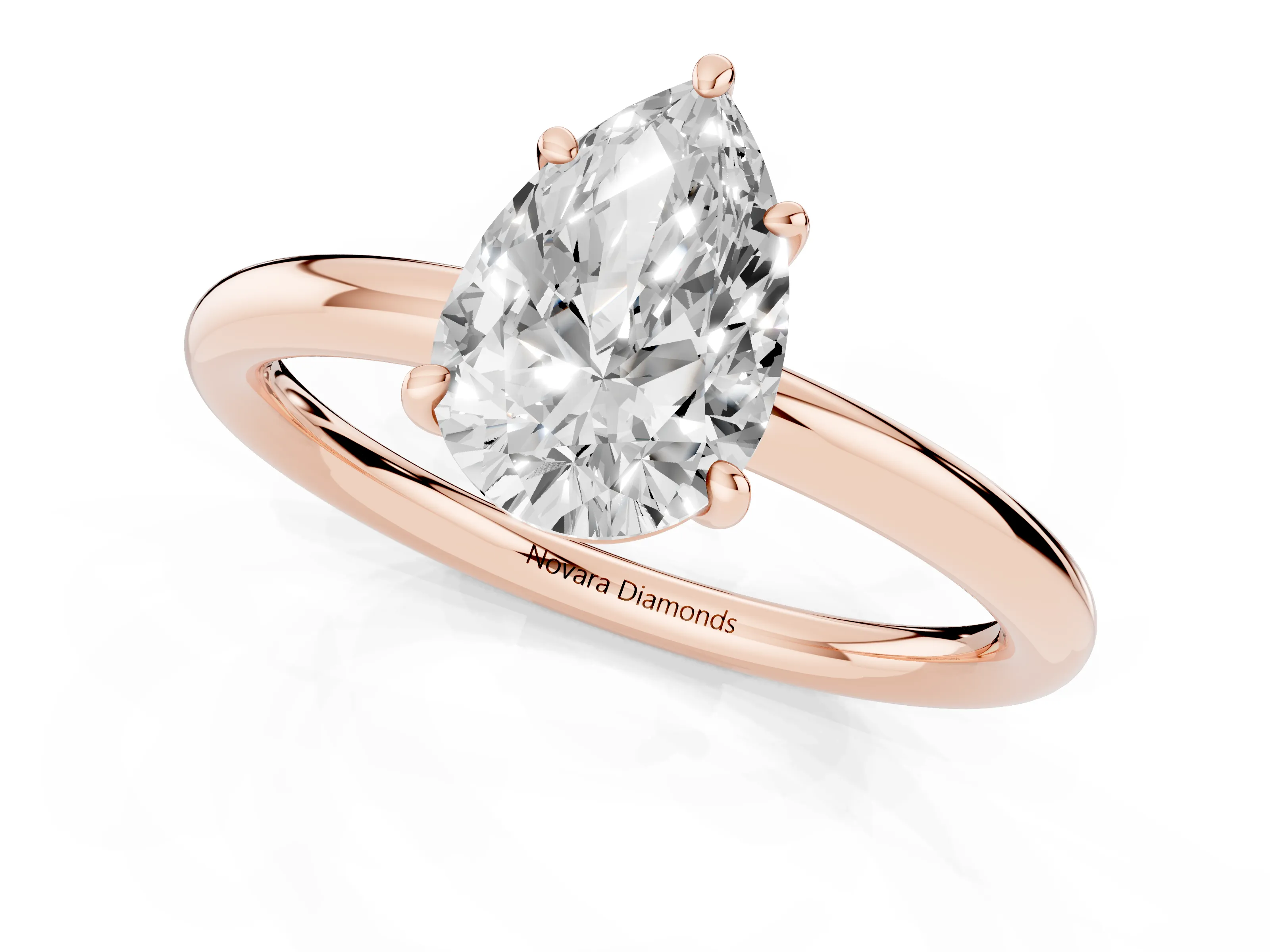 Pear Cut Diamond Solitaire Ring Set in Rose gold with Prong Setting on a Polished Plain Band