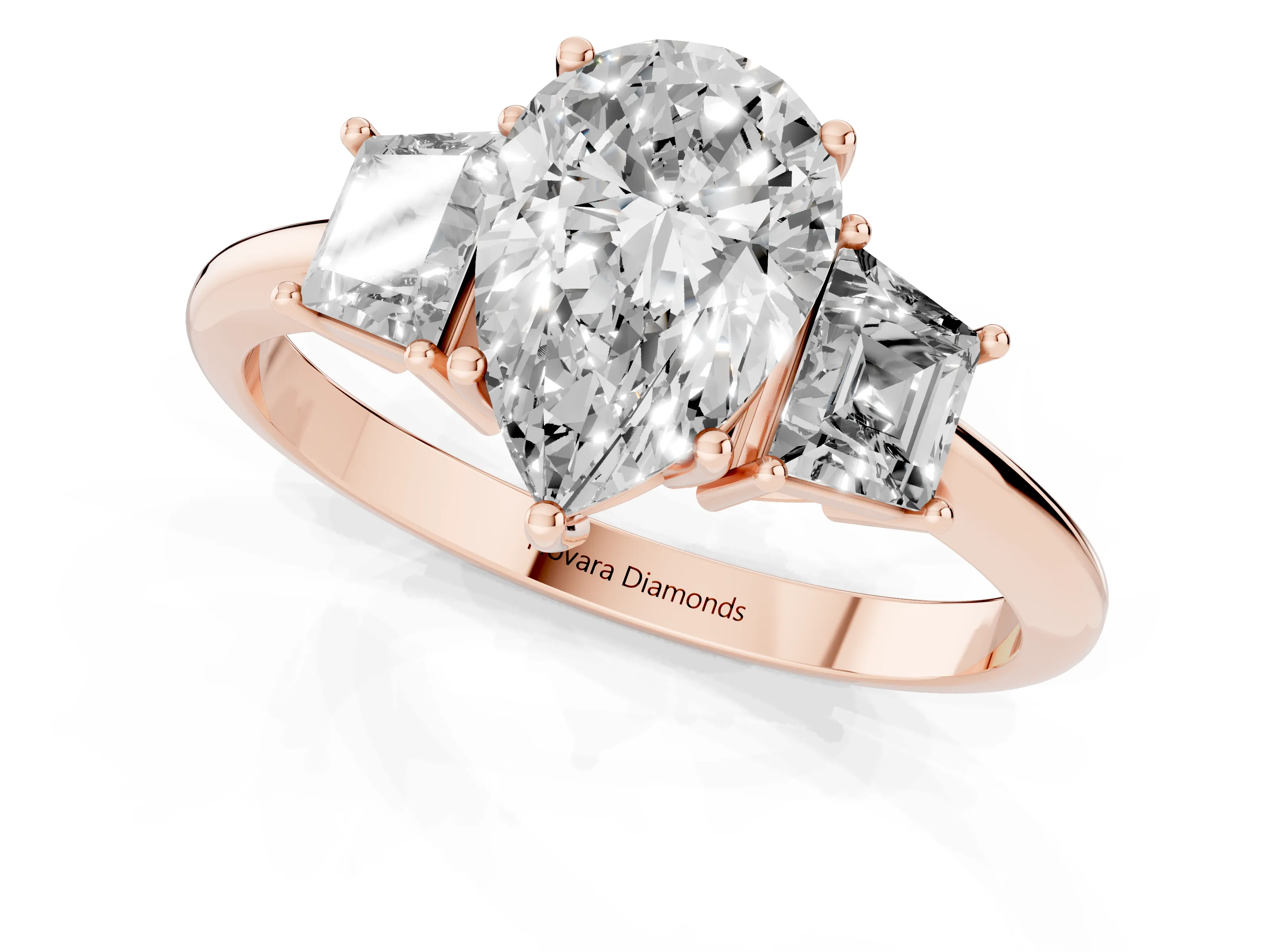 Pear Cut Diamond Three-Stone Ring Set in Rose gold with Trapezoid Side Stones and Prong Setting