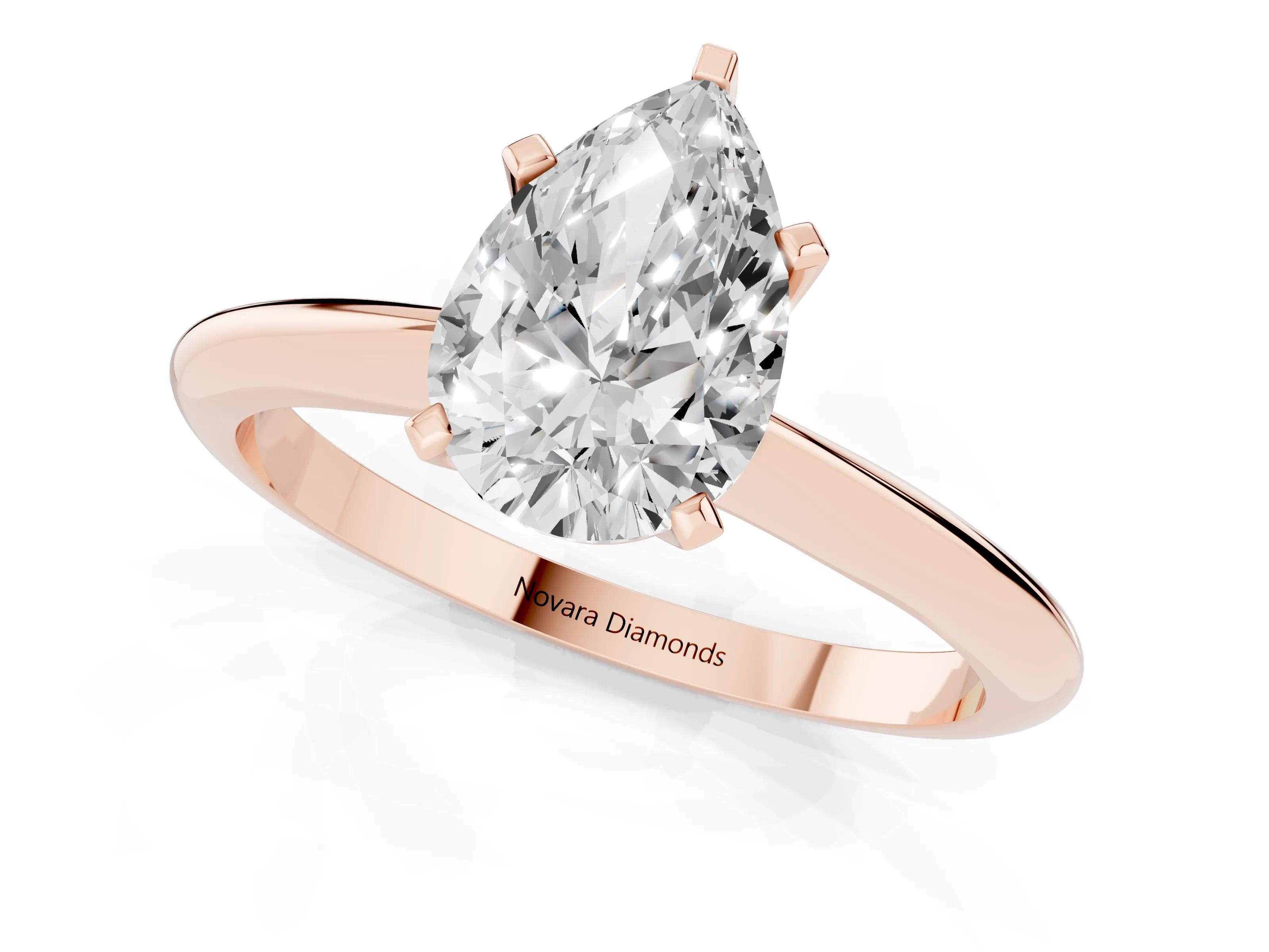 Pear Cut Diamond Solitaire Ring Set in Rose gold with Prong Setting on a Plain Round Band