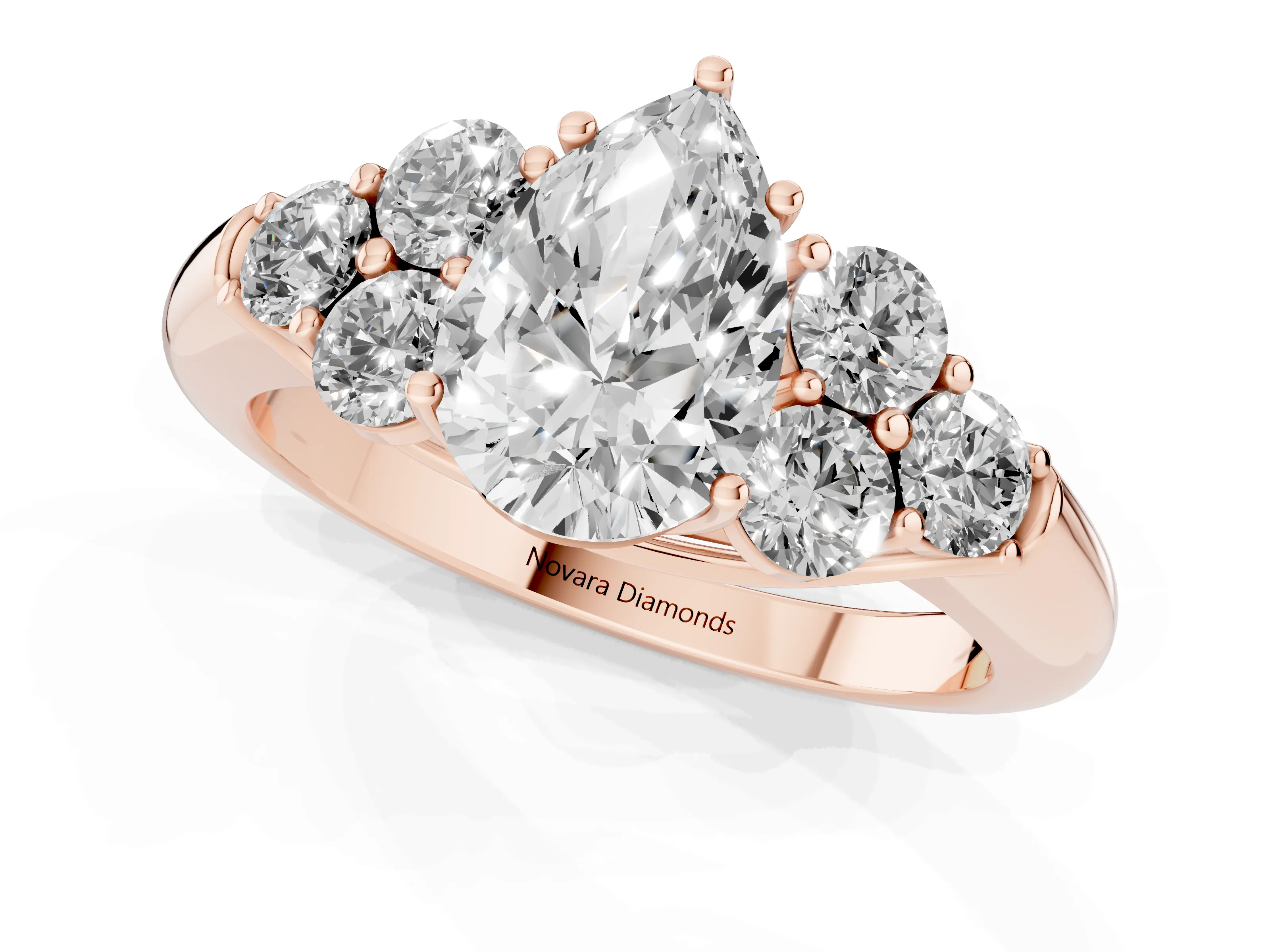 Pear Cut Diamond Cluster Ring Set in Rose gold with Round Accent Stones and Prong Setting on a Plain Band