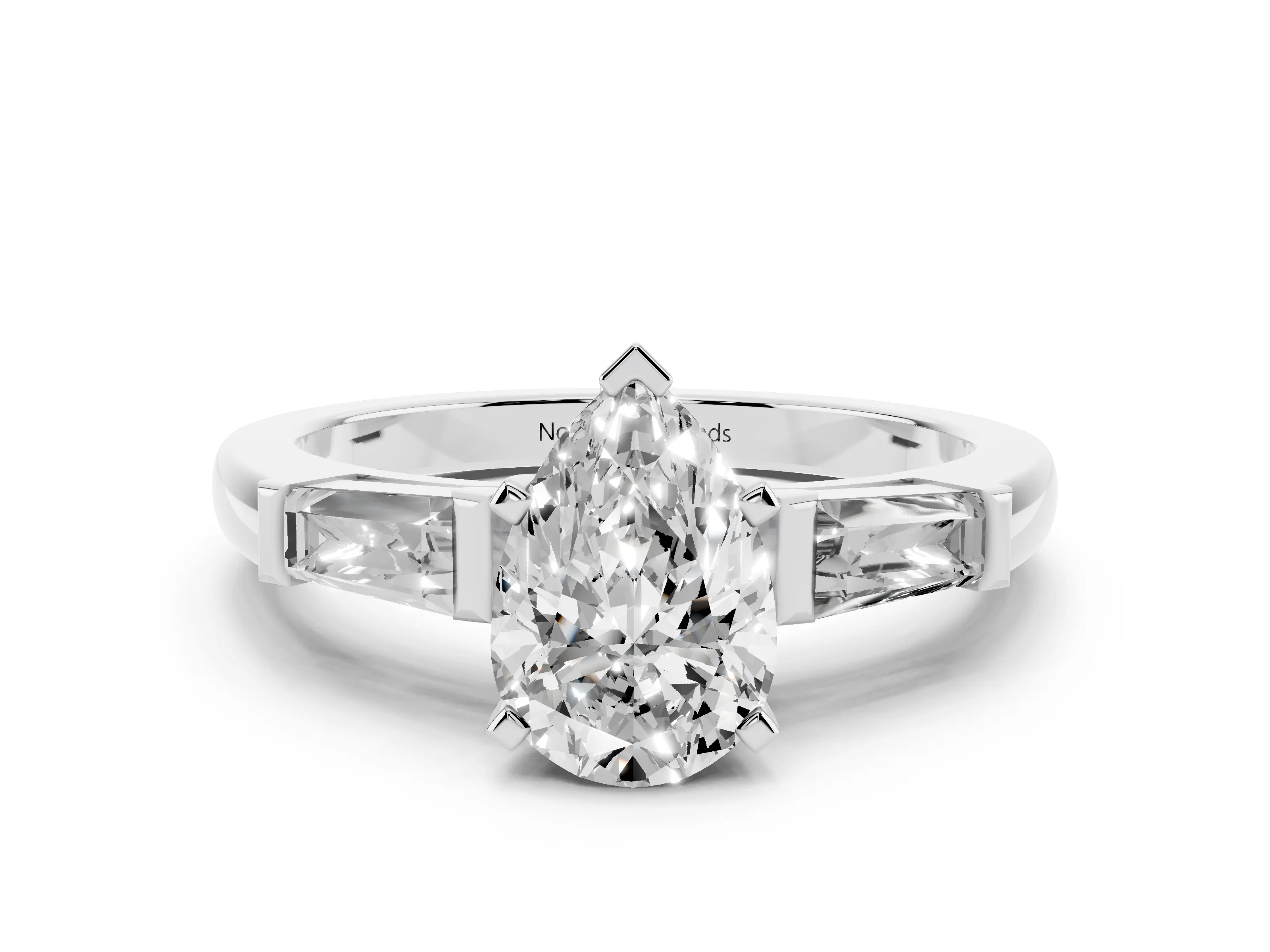Pear Cut Diamond Solitaire Ring Set in Platinum with Tapered Baguette Side Stones and Prong Setting