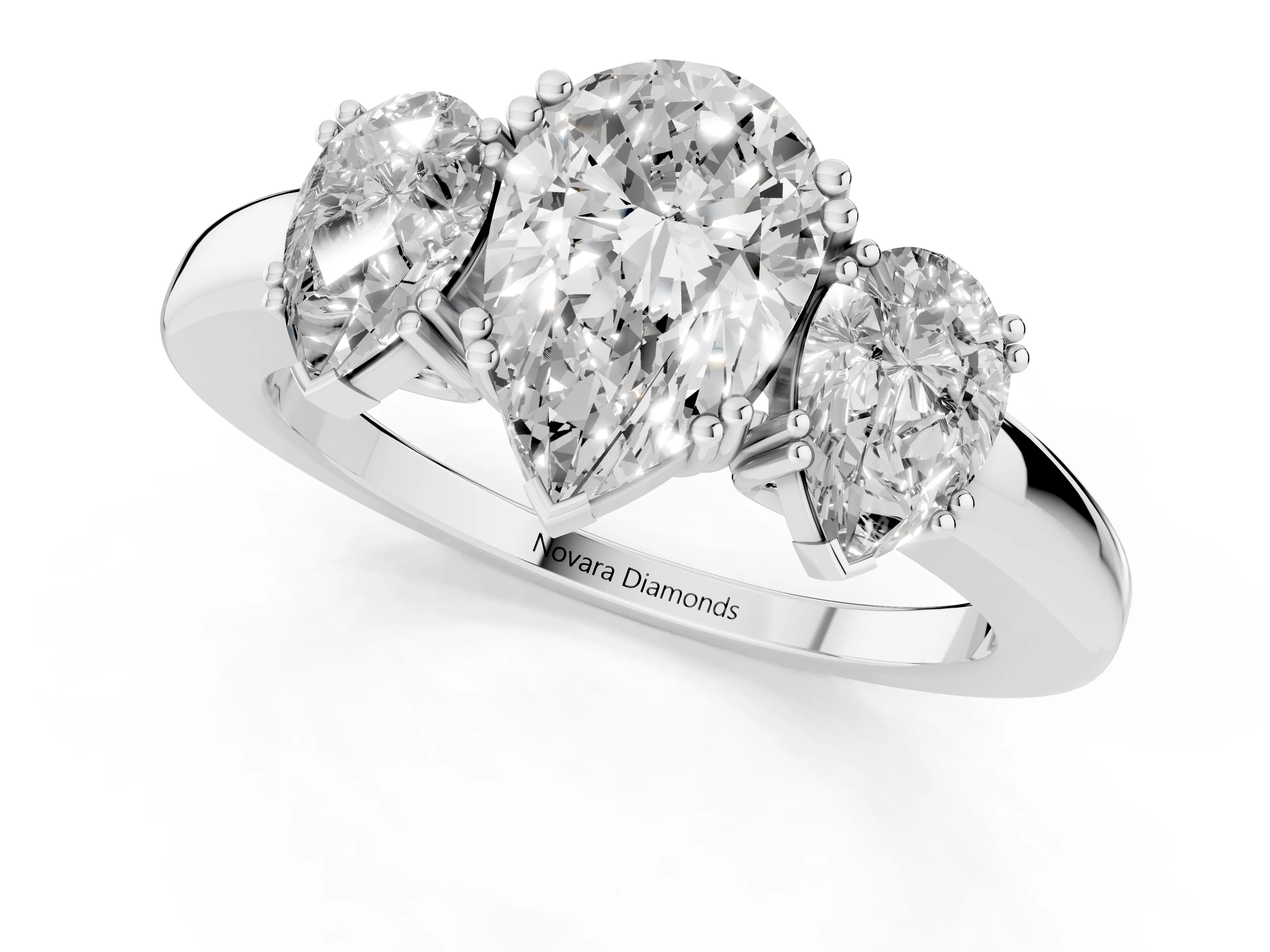 Pear Cut Diamond Three-Stone Ring Set in Platinum with Polished Channel-Set Band
