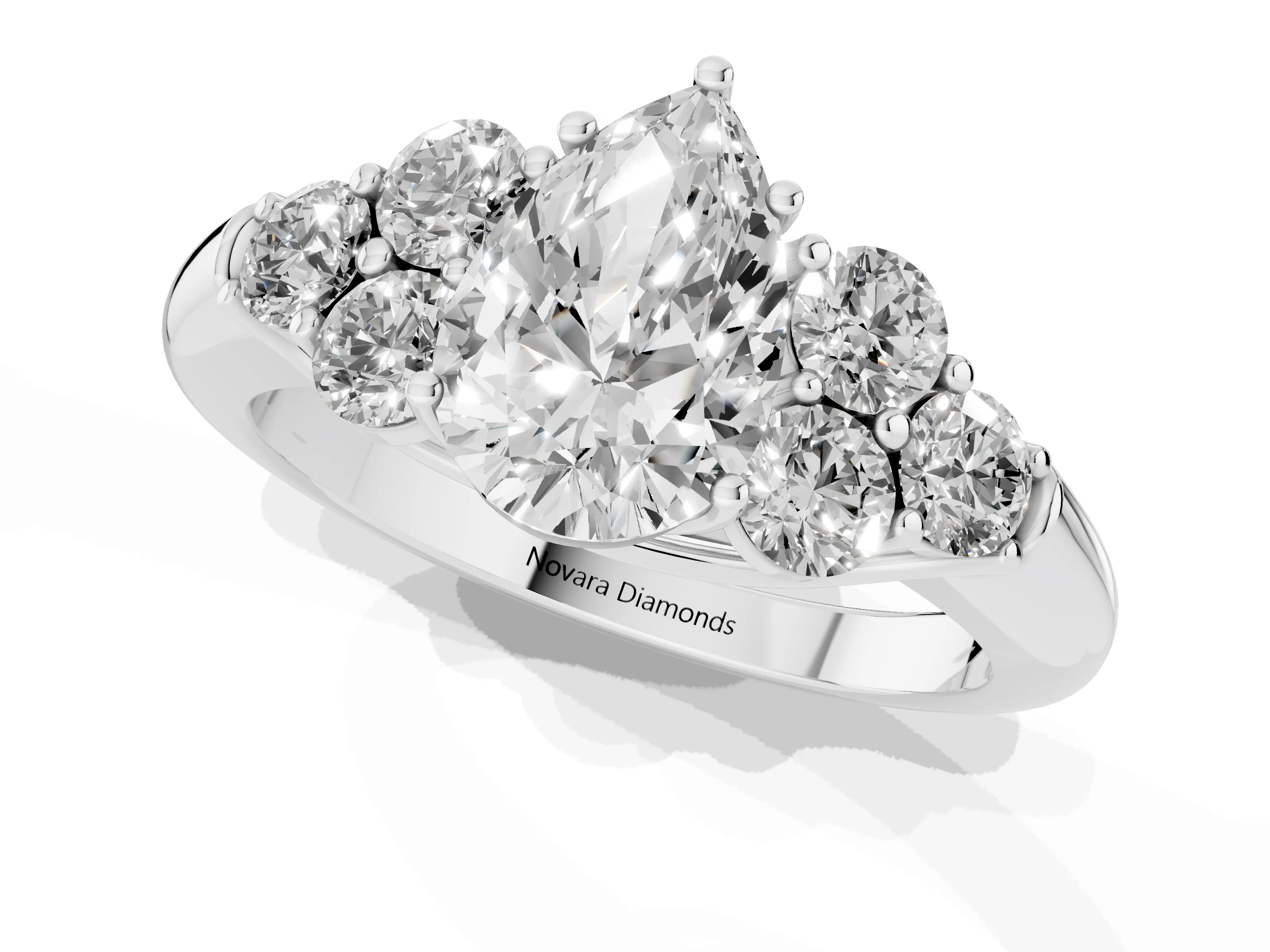 Pear Cut Diamond Cluster Ring Set in Platinum with Round Accent Stones and Prong Setting on a Plain Band