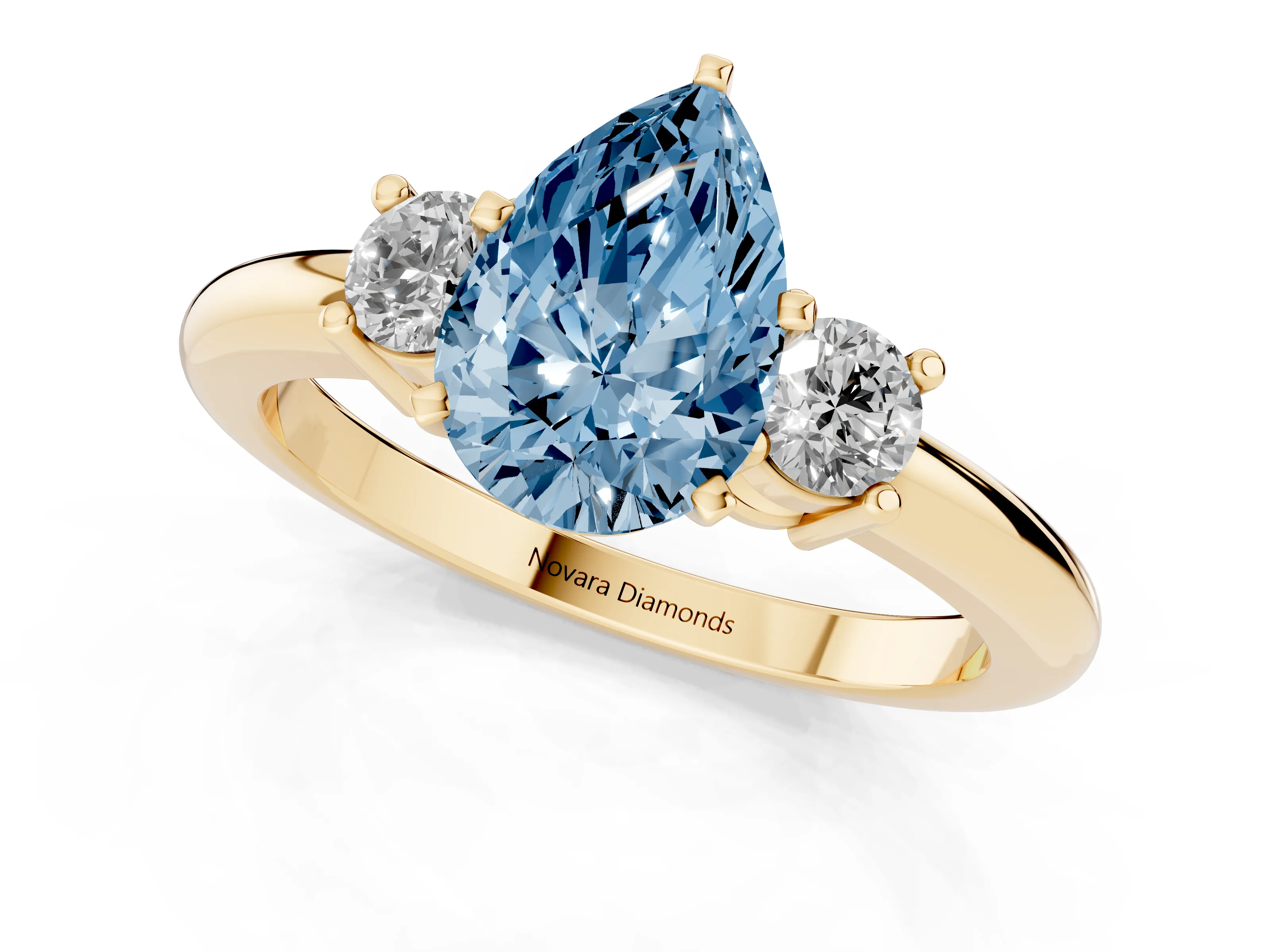 Fancy Blue Three-Stone Pear Cut Diamond Ring Set in Yellow gold with Prong Setting and Plain Band