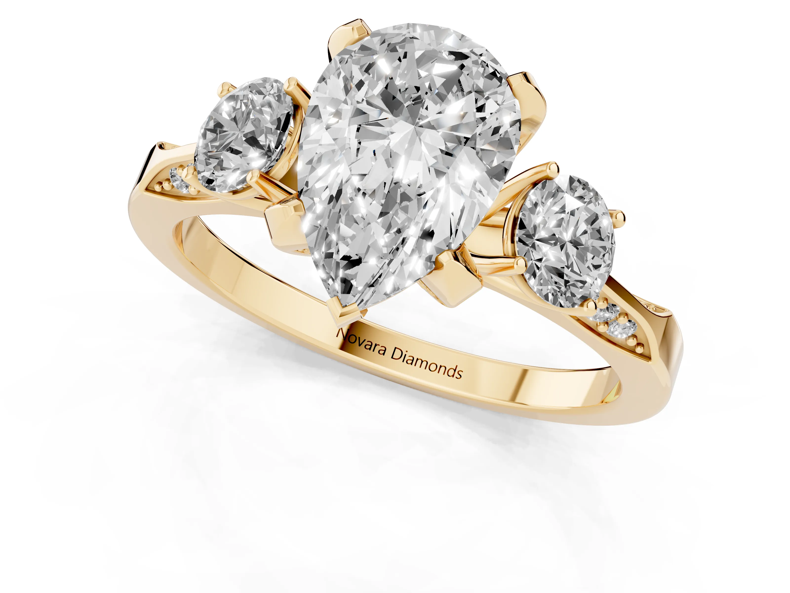 Pear Cut Diamond Three-Stone Ring Set in Yellow gold with Pavé Band and Smaller Side Stones