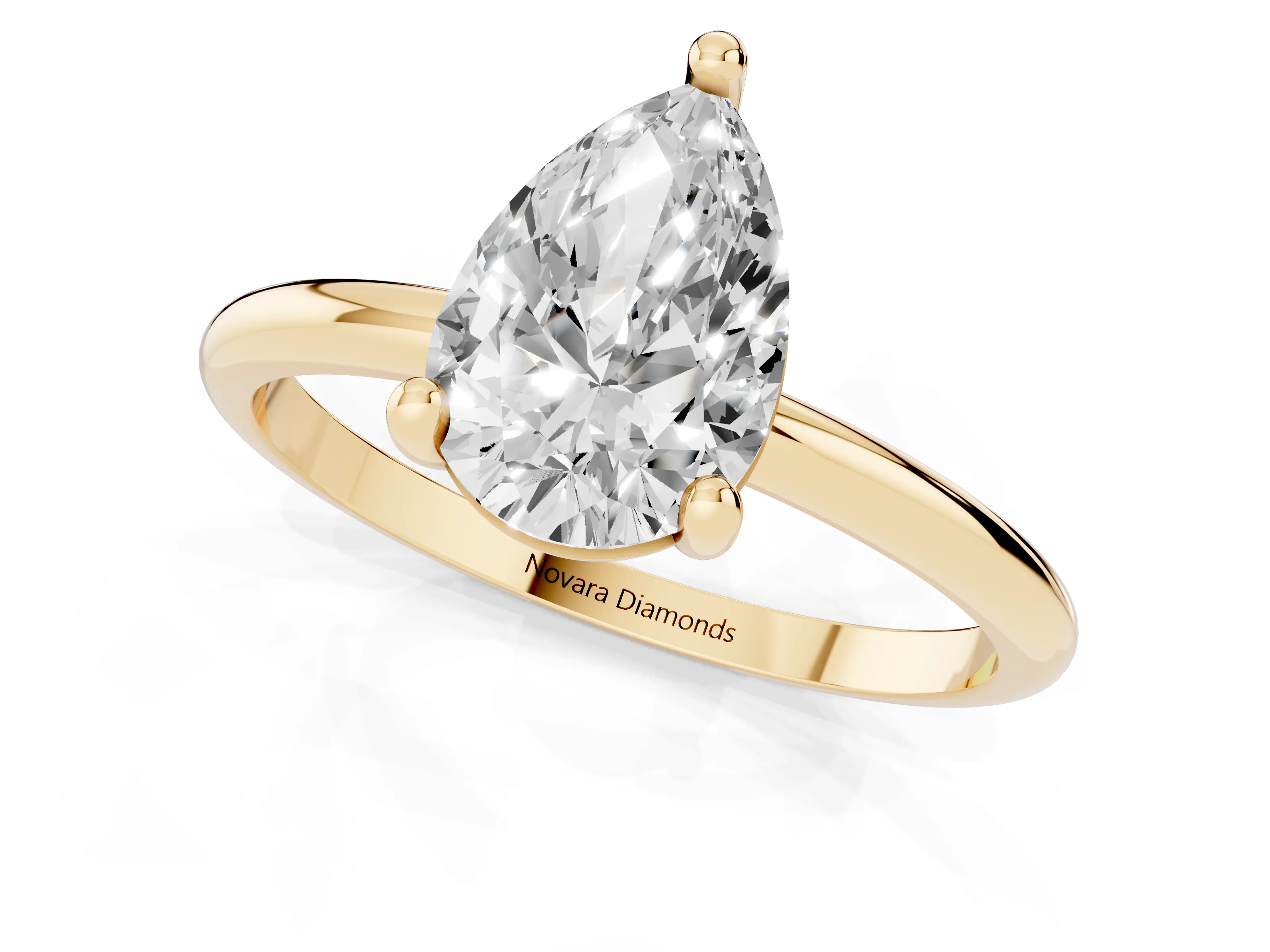 Pear Cut Diamond Solitaire Ring Set in Yellow gold with Secure Prong Setting on a Classic Band