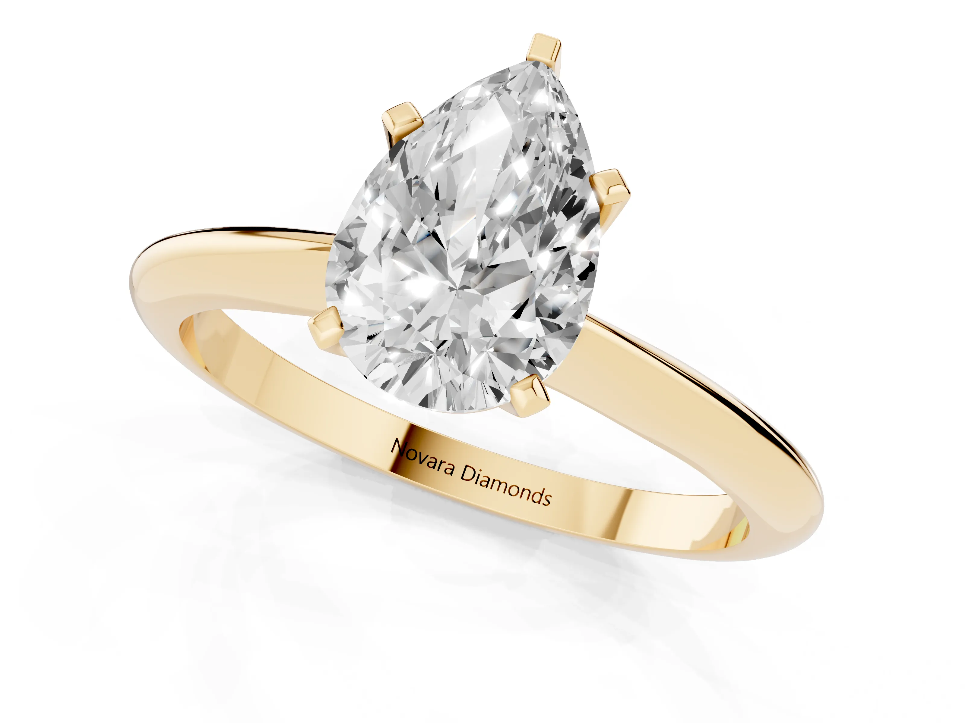 Pear Cut Diamond Solitaire Ring Set in Yellow gold with Prong Setting on a Plain Round Band