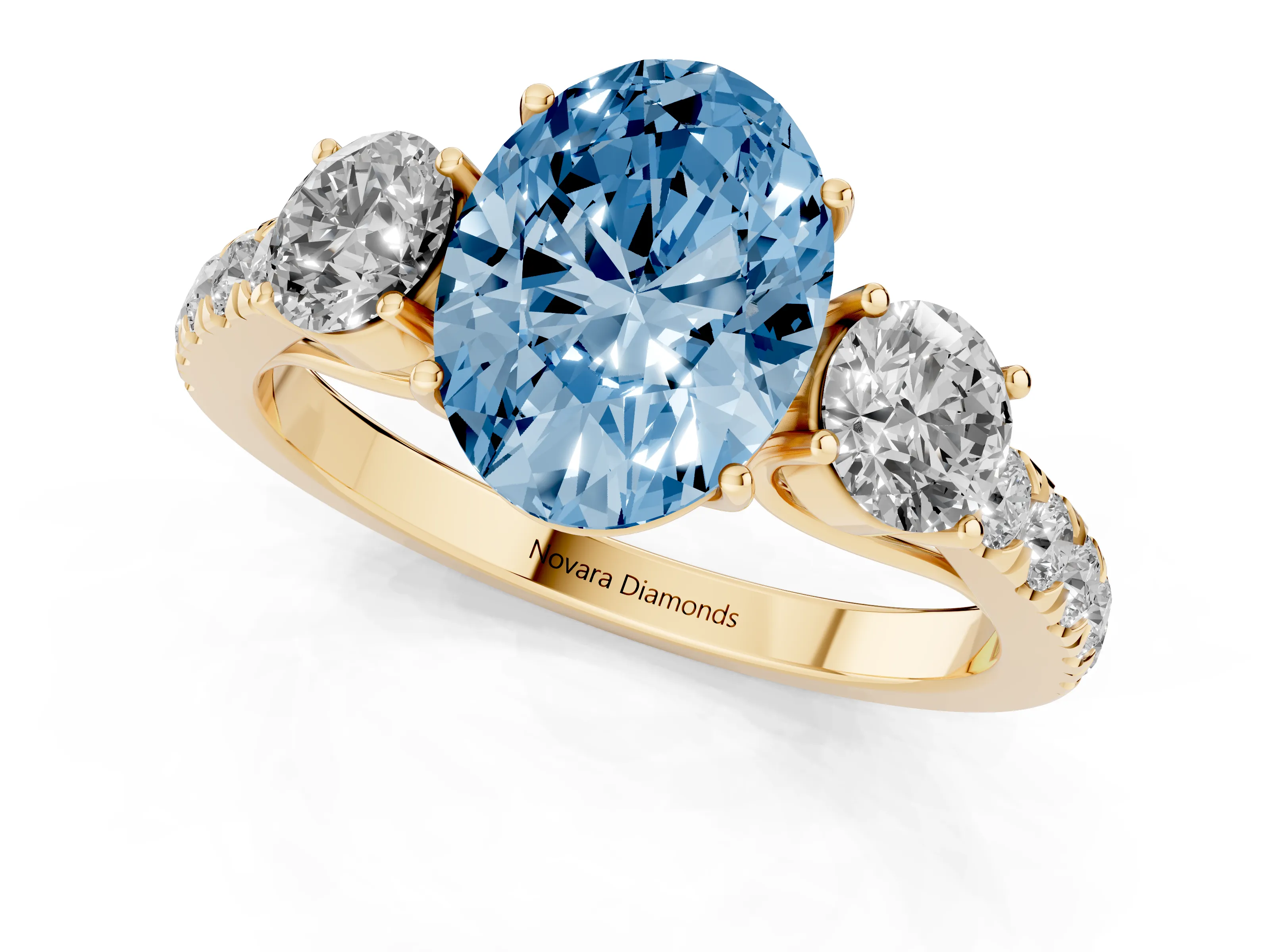 Fancy Blue Oval Cut Diamond Three-Stone Ring Set in Yellow gold with Round Side Stones and Delicate Pavé Band