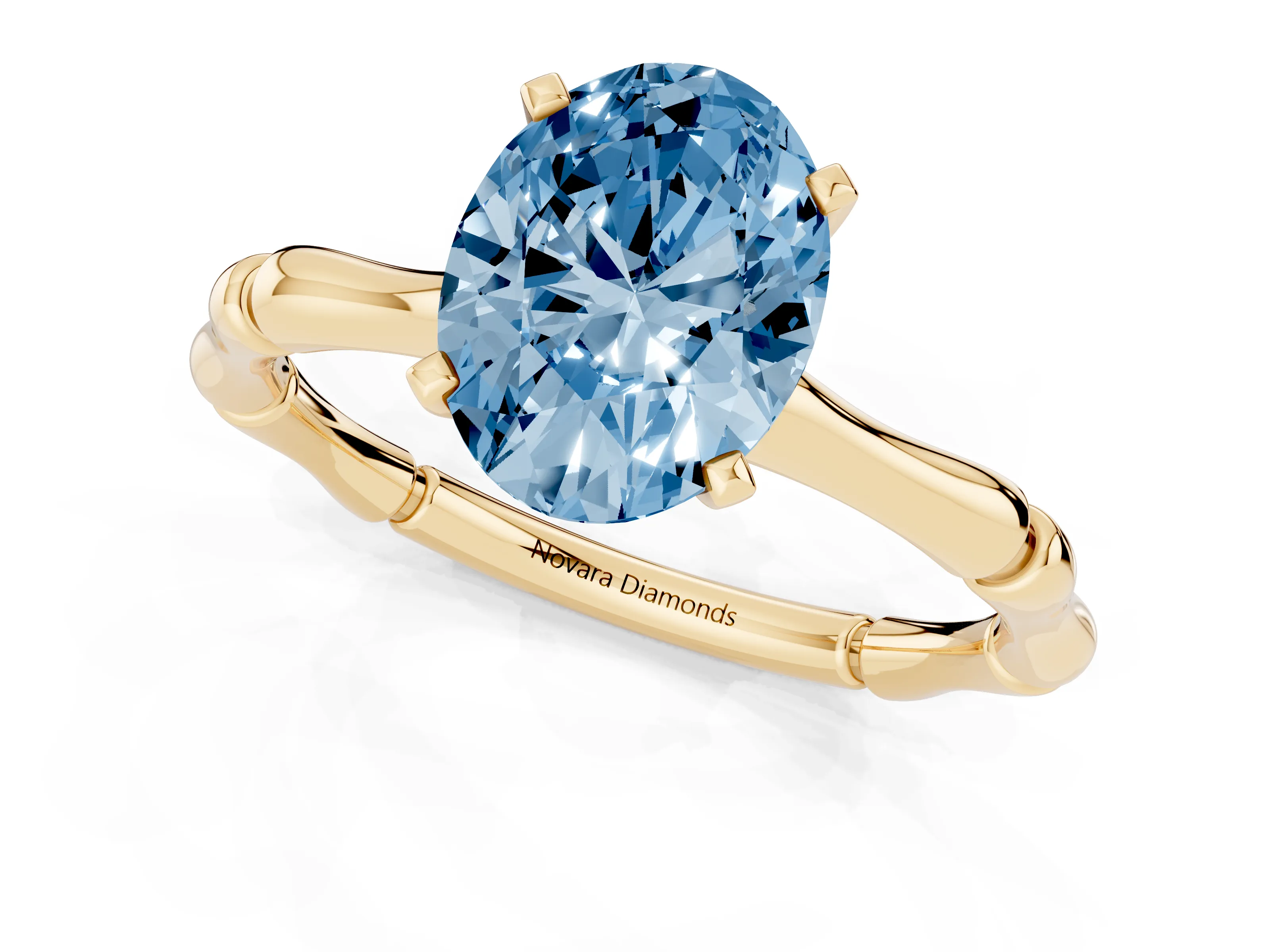 Fancy Blue Oval Cut Diamond Solitaire Ring Set in Yellow gold with Bamboo Band and Prong Setting
