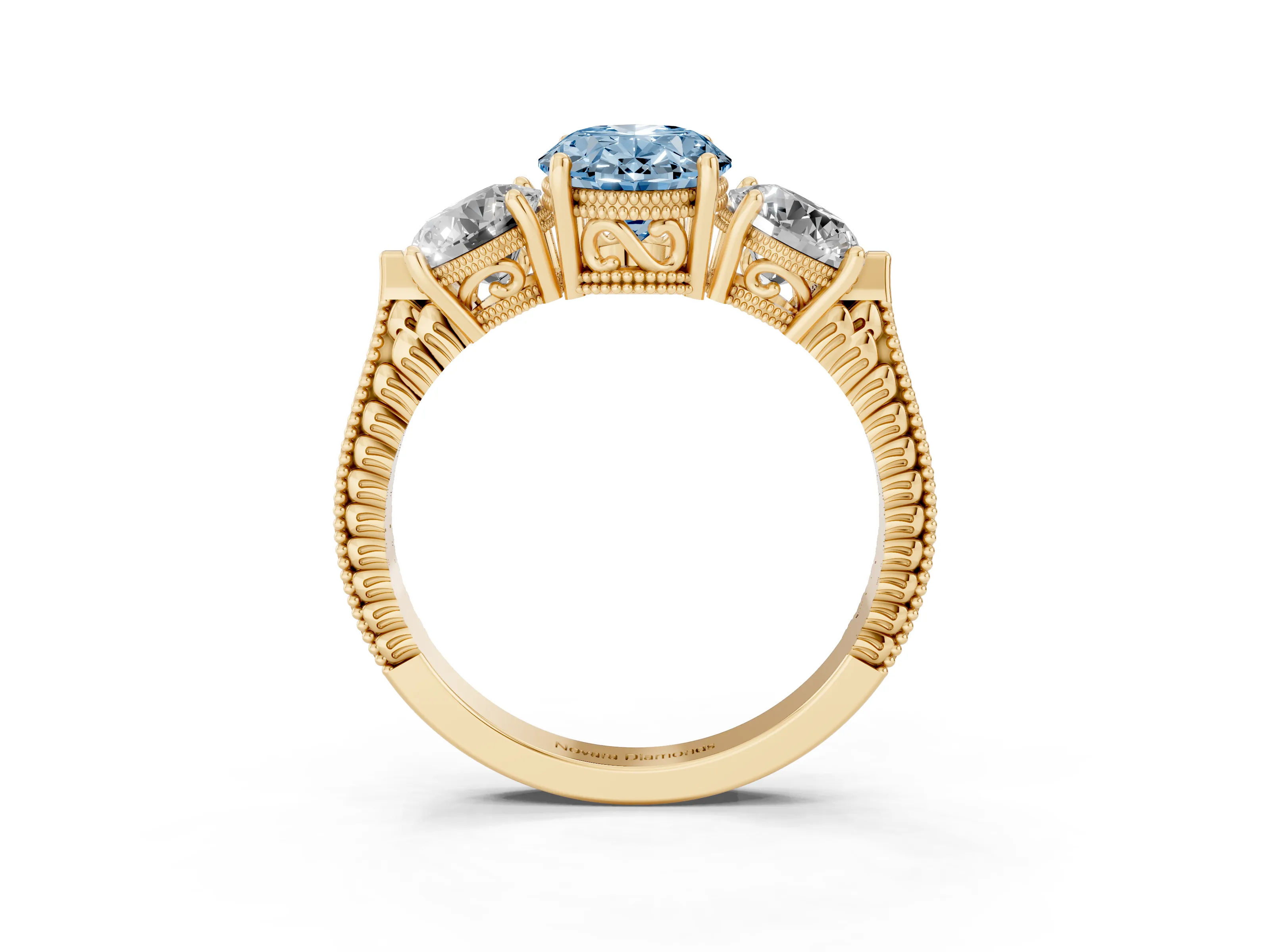Fancy Blue Oval Cut Diamond Three-Stone Ring Set in Yellow gold with Milgrain Band