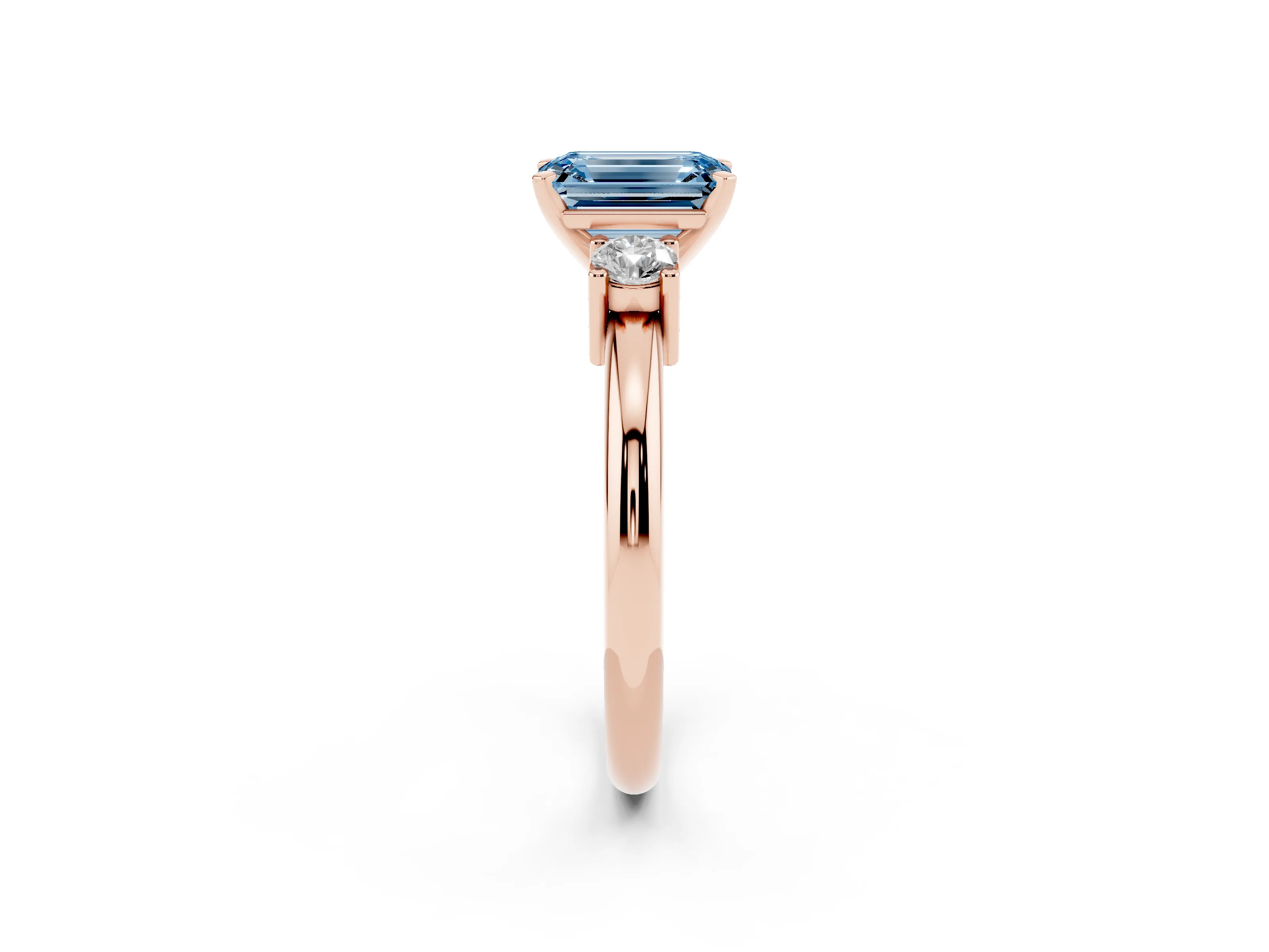 Fancy Blue Three-Stone Emerald Cut Diamond Ring Set in Rose gold with Prong Setting and Plain Band