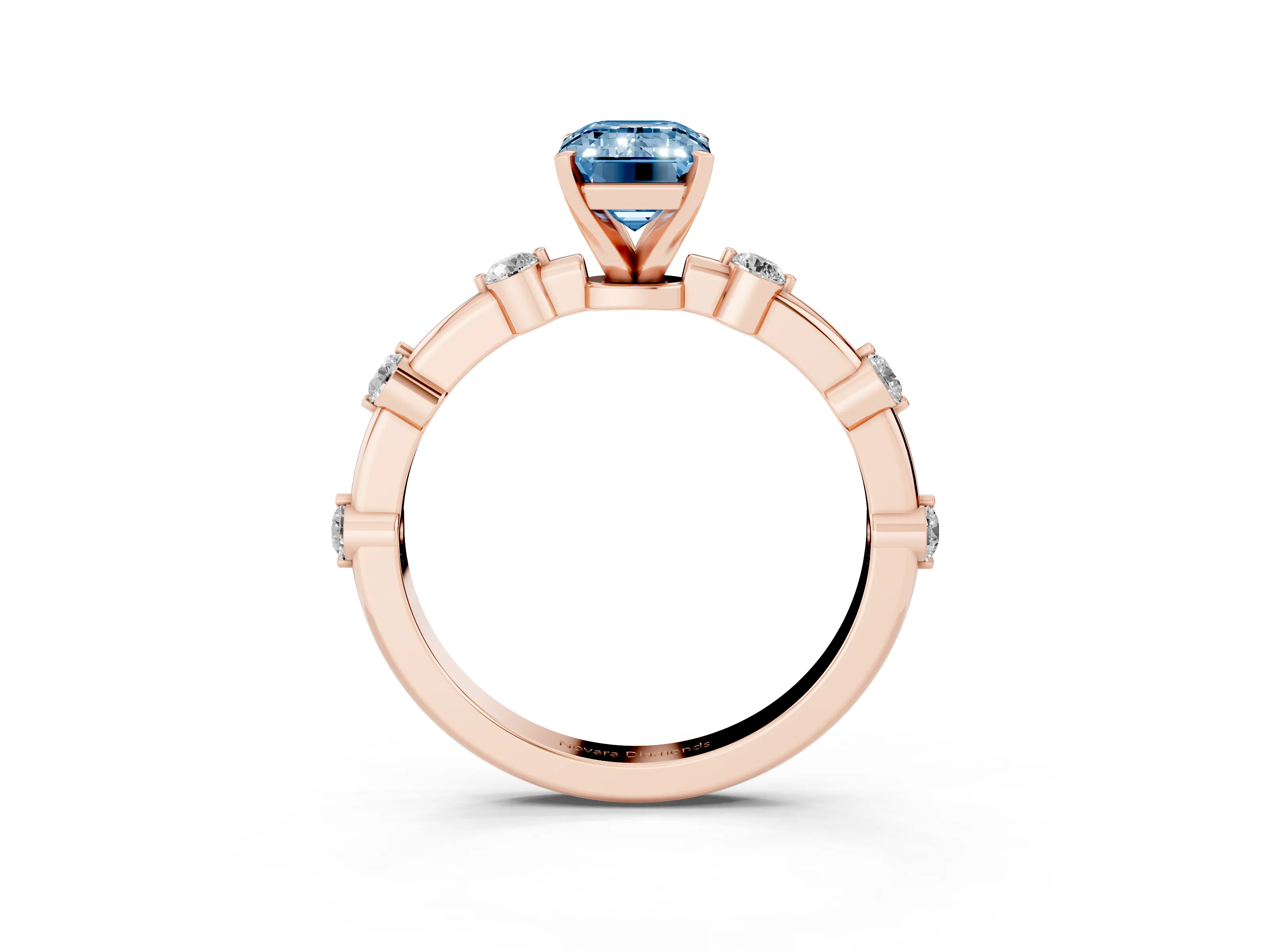 Fancy Blue Emerald Cut Diamond Solitaire Ring Set in Rose gold with Bezel Set Side Stones and Prong Setting