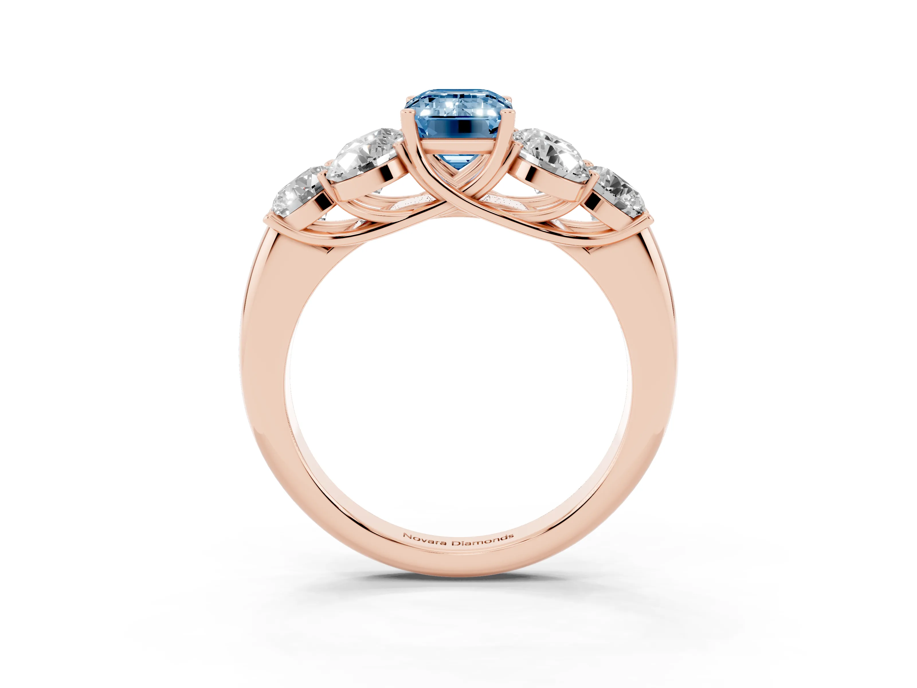 Fancy Blue Emerald Cut Diamond Cluster Ring Set in Rose gold with Round Accent Stones and Prong Setting on a Plain Band