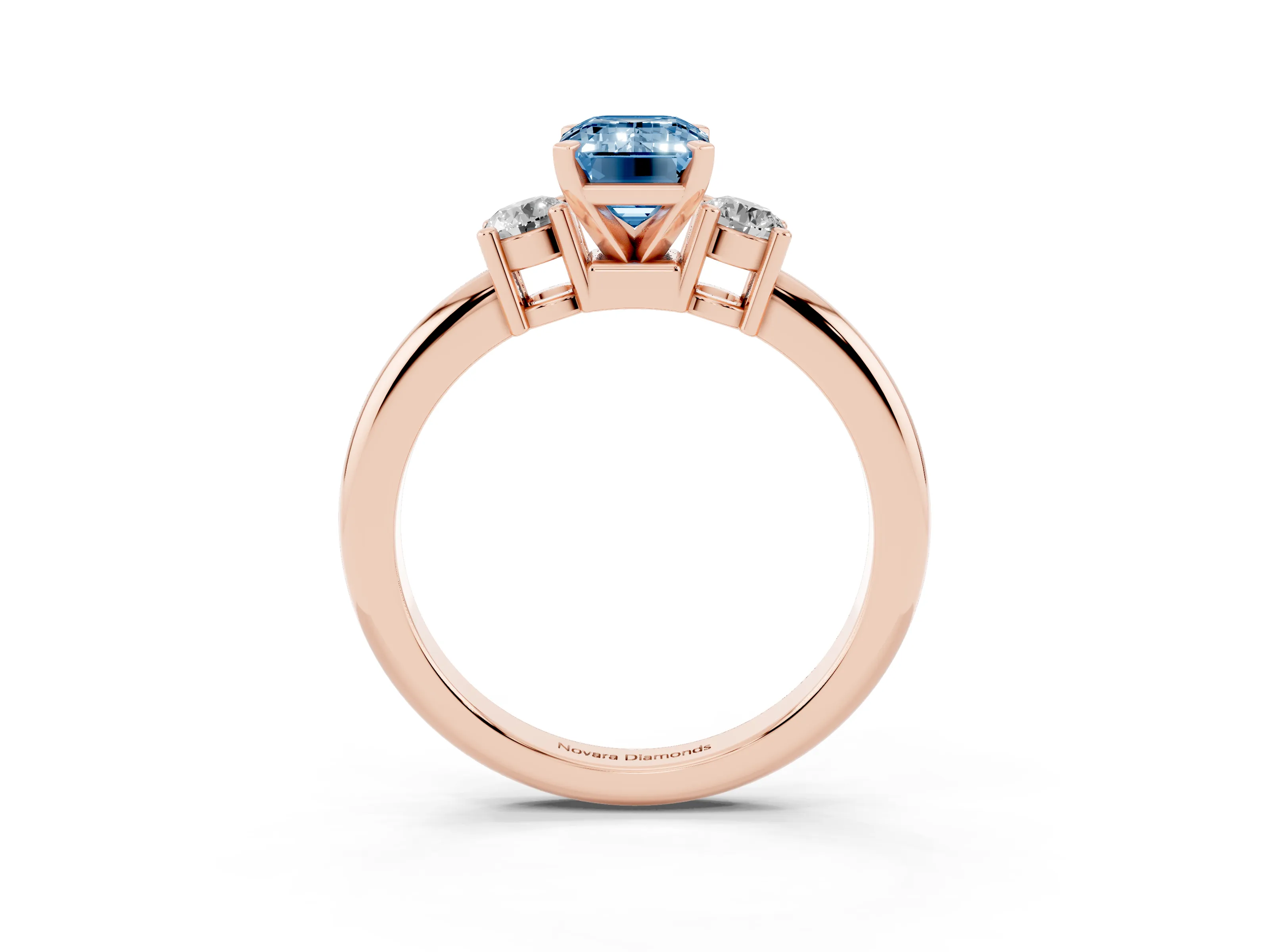 Fancy Blue Three-Stone Emerald Cut Diamond Ring Set in Rose gold with Prong Setting and Plain Band