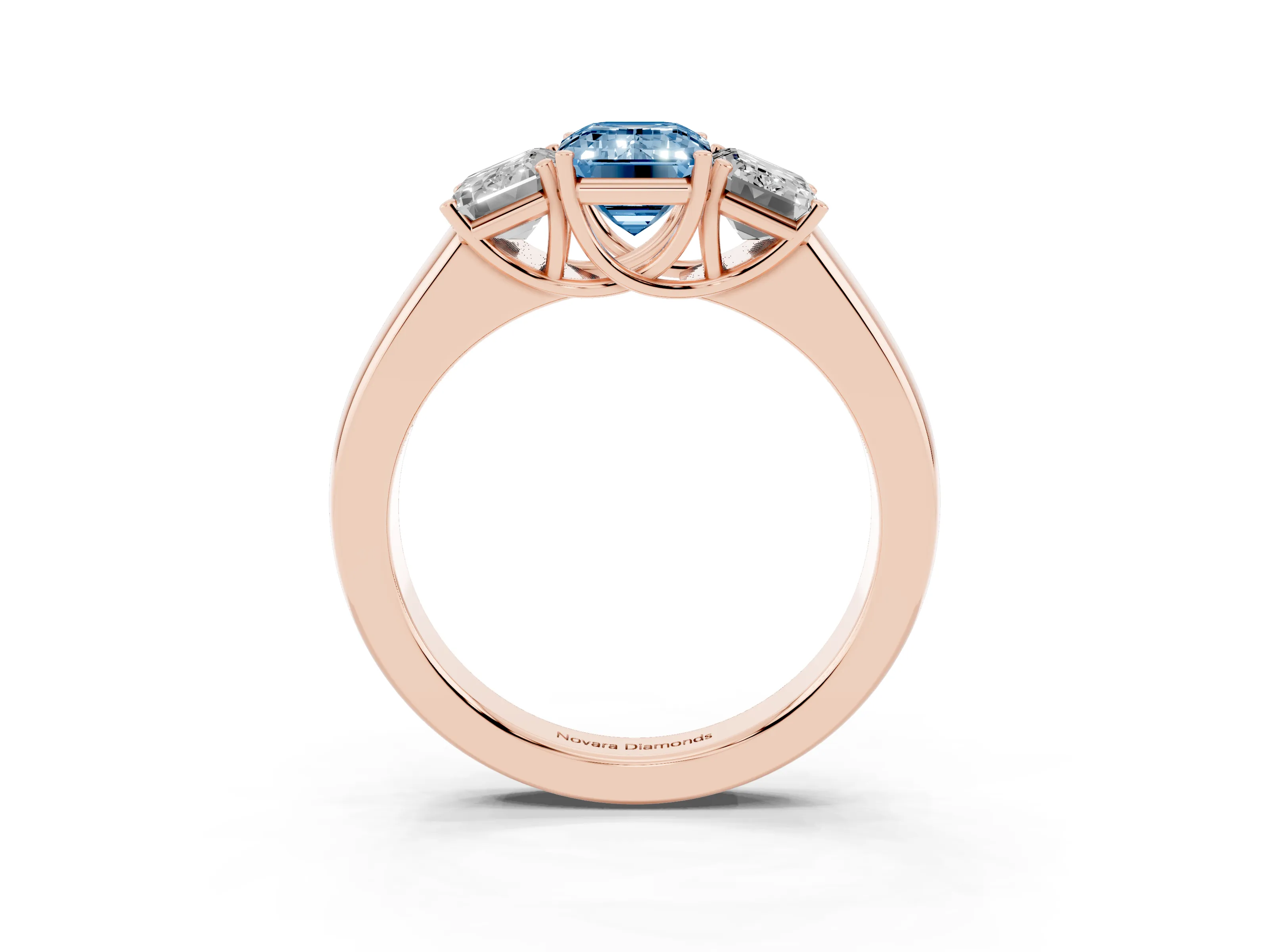 Fancy Blue Three-Stone Emerald Cut Diamond Ring Set in Rose gold with Matching Prong Settings and Plain Band
