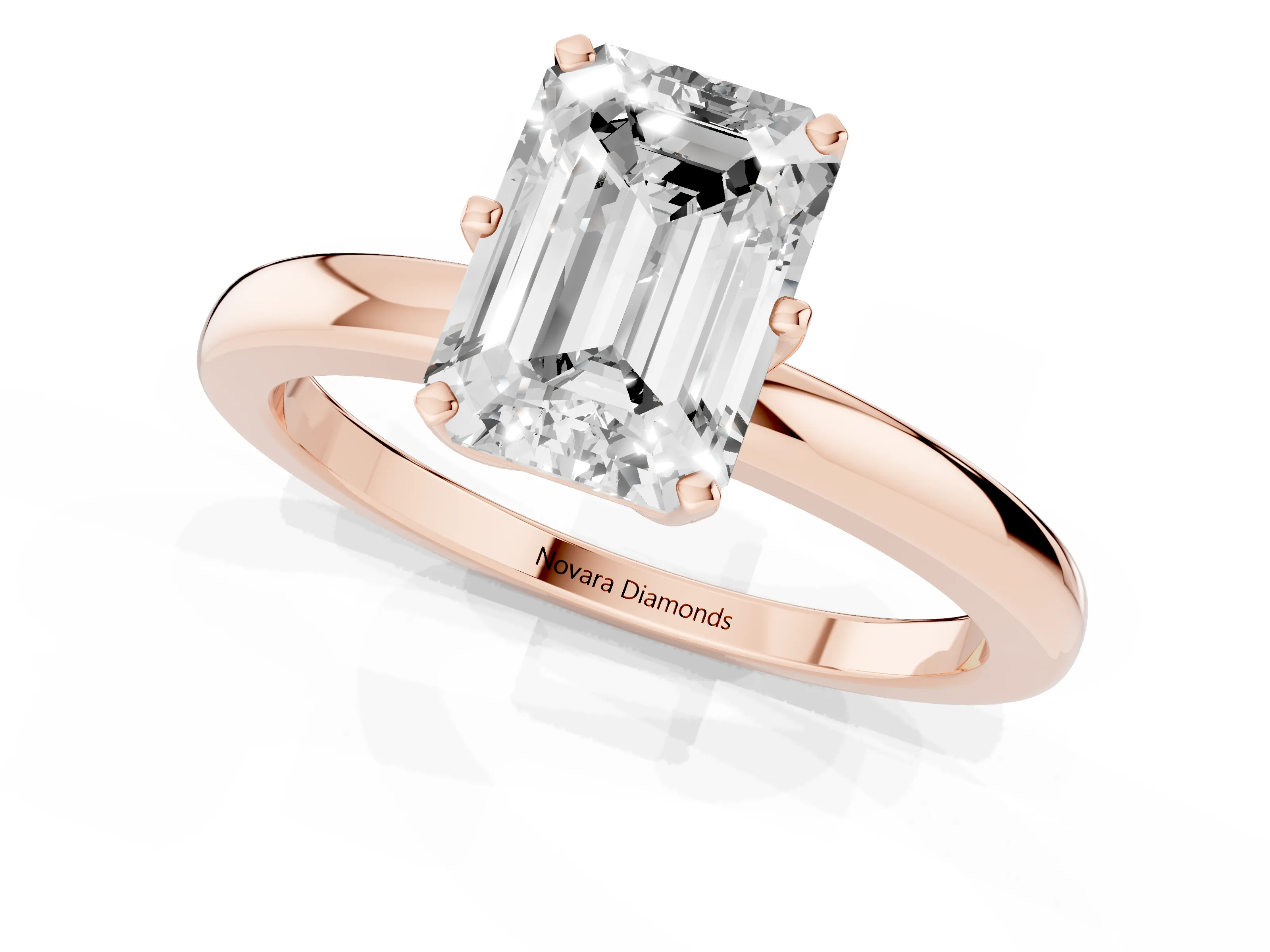 Emerald Cut Diamond Solitaire Ring Set in Rose gold with Raised Prong Setting on a Classic Band