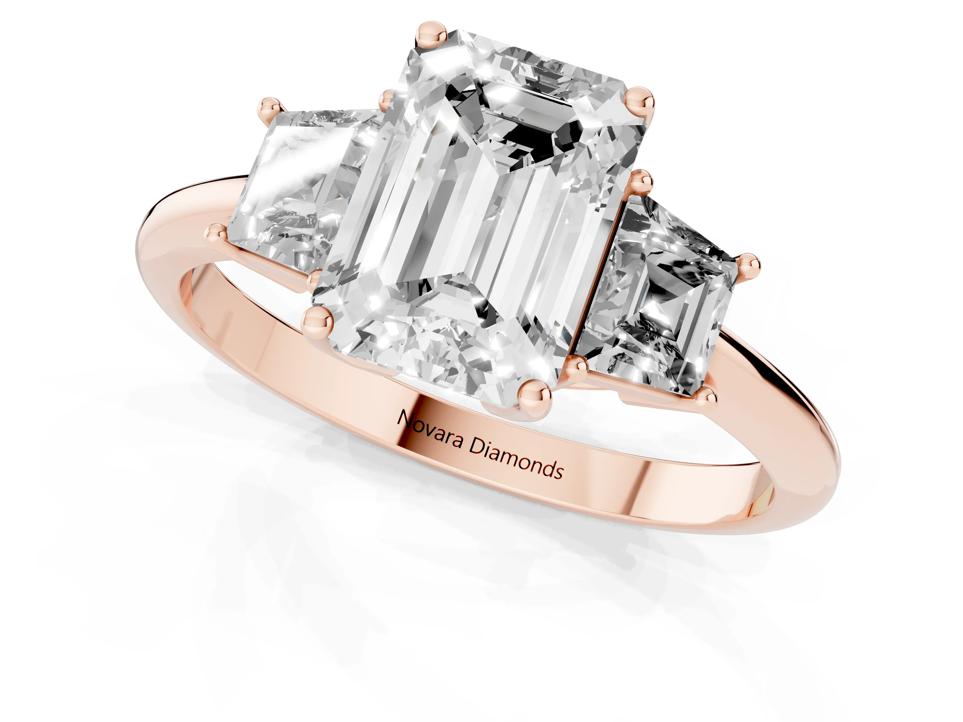 Emerald Cut Diamond Three-Stone Ring Set in Rose gold with Trapezoid Side Stones and Prong Setting