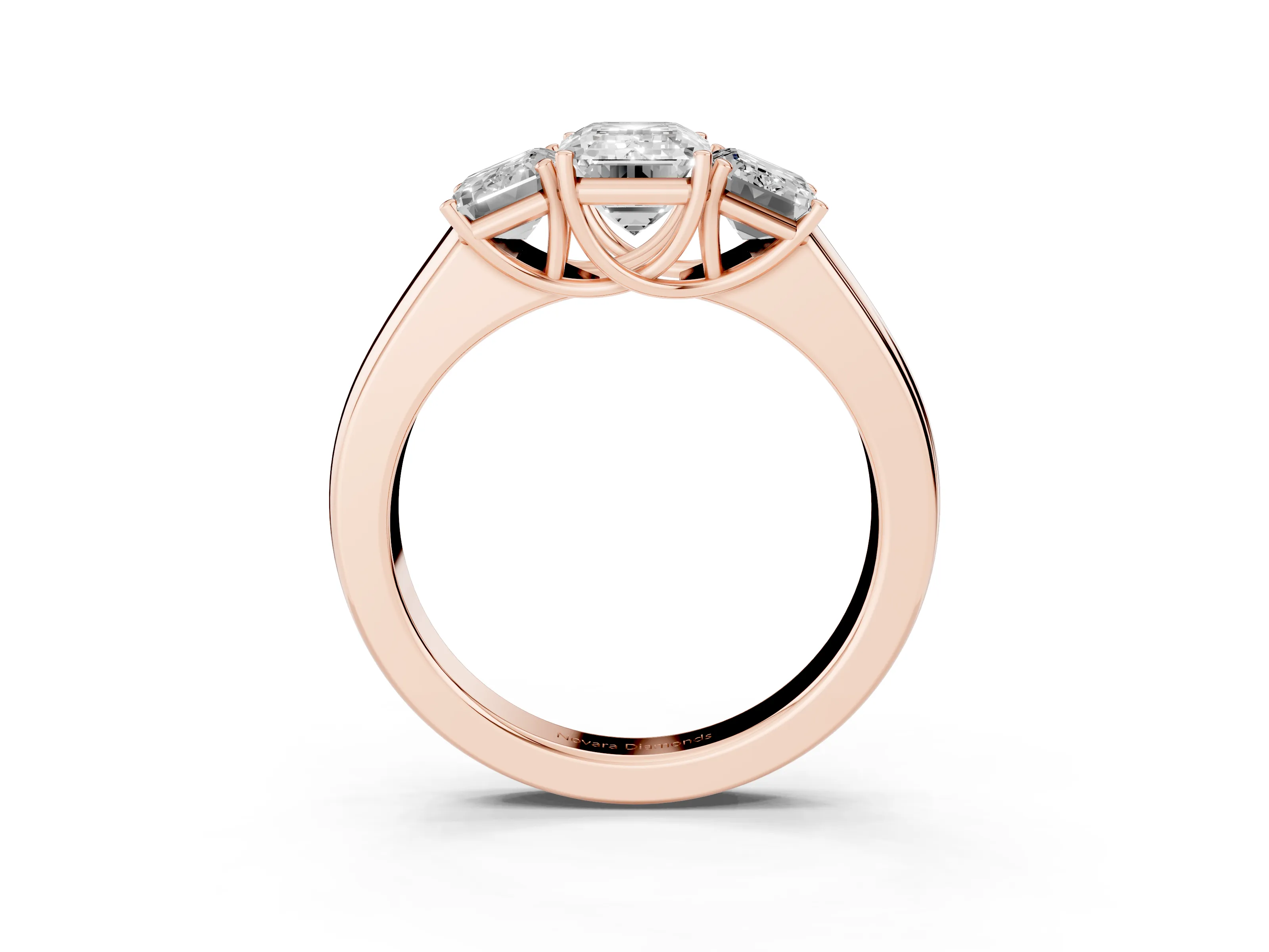 Three-Stone Emerald Cut Diamond Ring Set in Rose gold with Matching Prong Settings and Plain Band