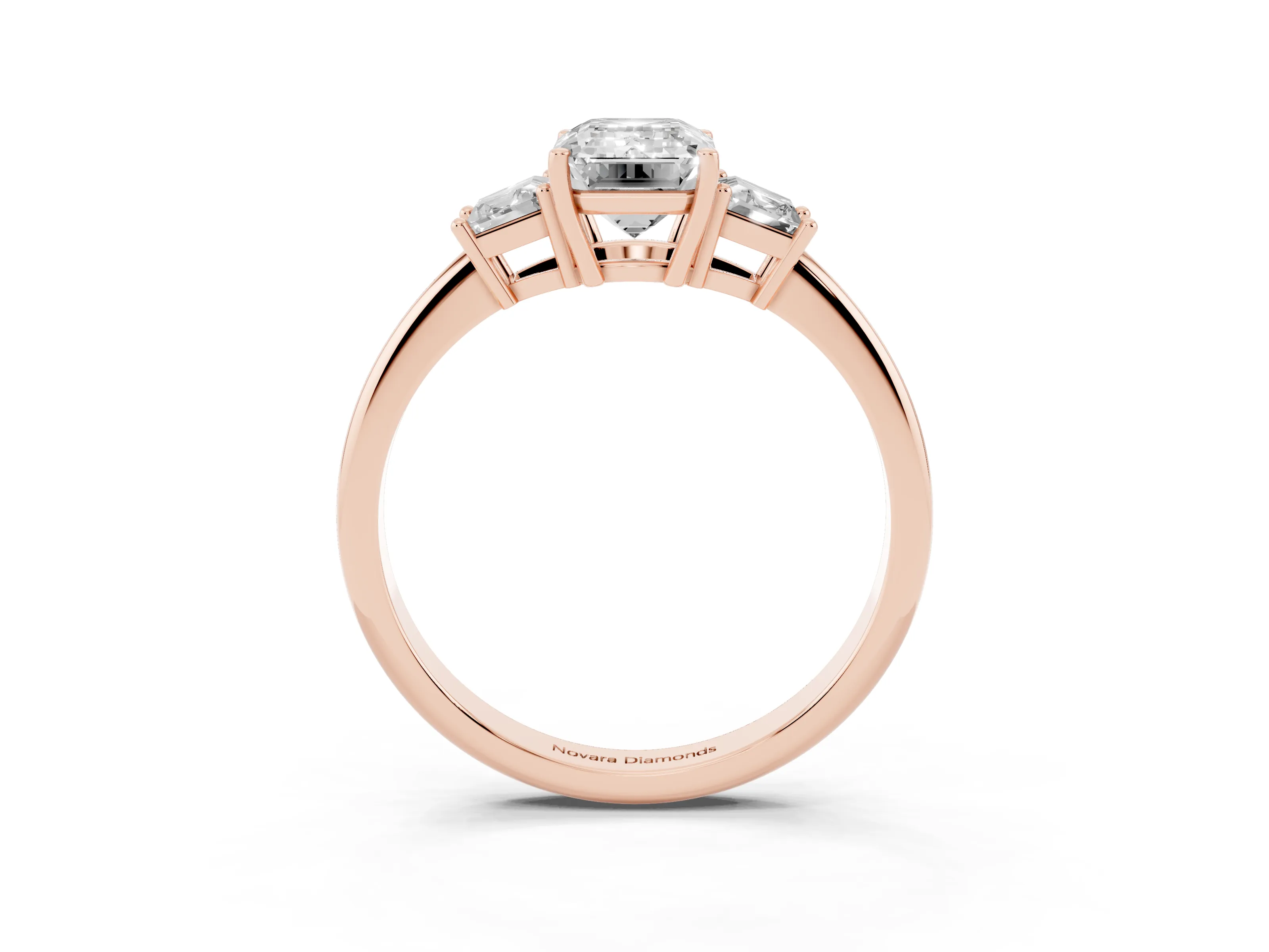 Emerald Cut Diamond Three-Stone Ring Set in Rose gold with Trapezoid Side Stones and Prong Setting
