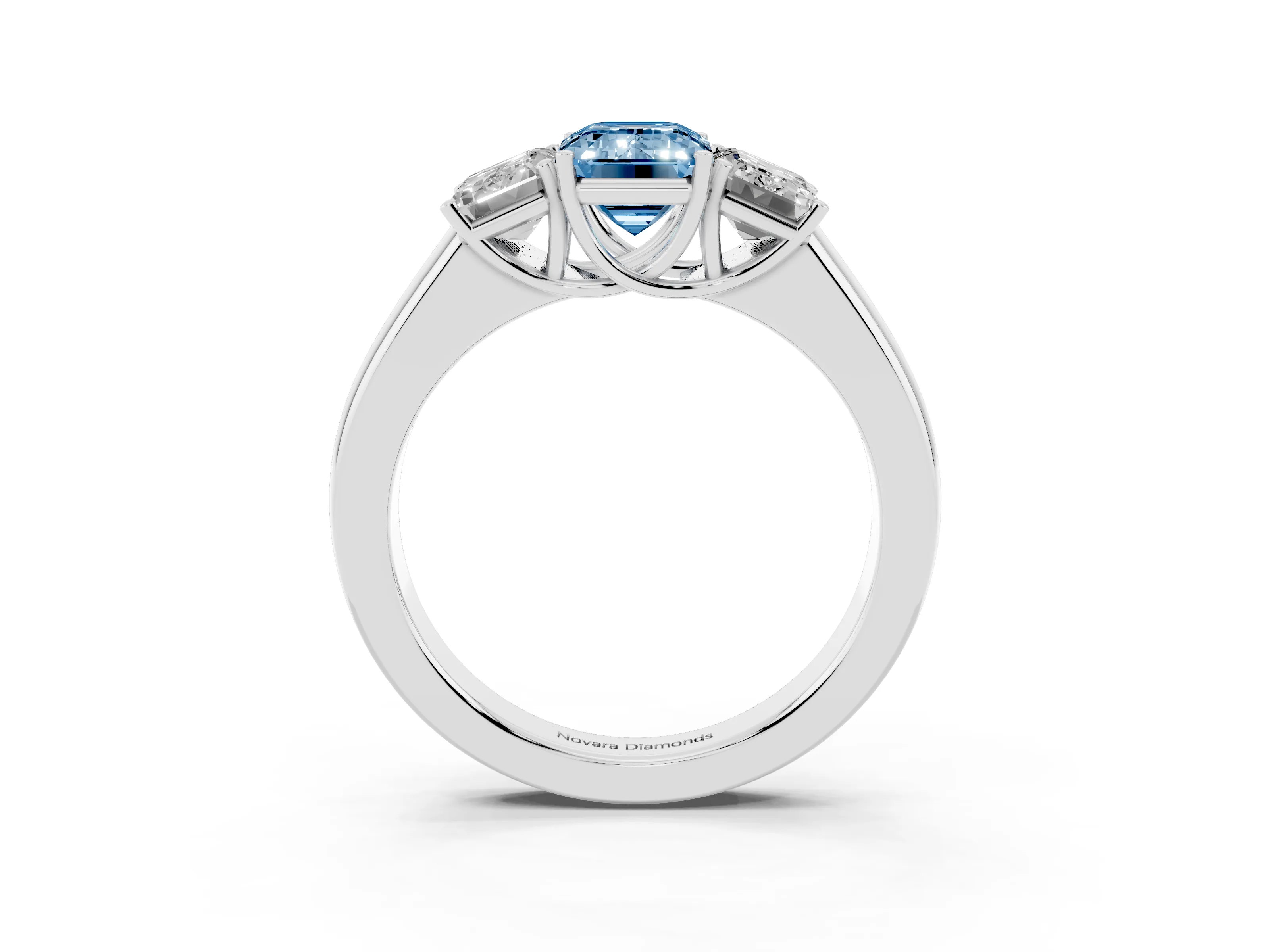 Fancy Blue Three-Stone Emerald Cut Diamond Ring Set in Platinum with Matching Prong Settings and Plain Band